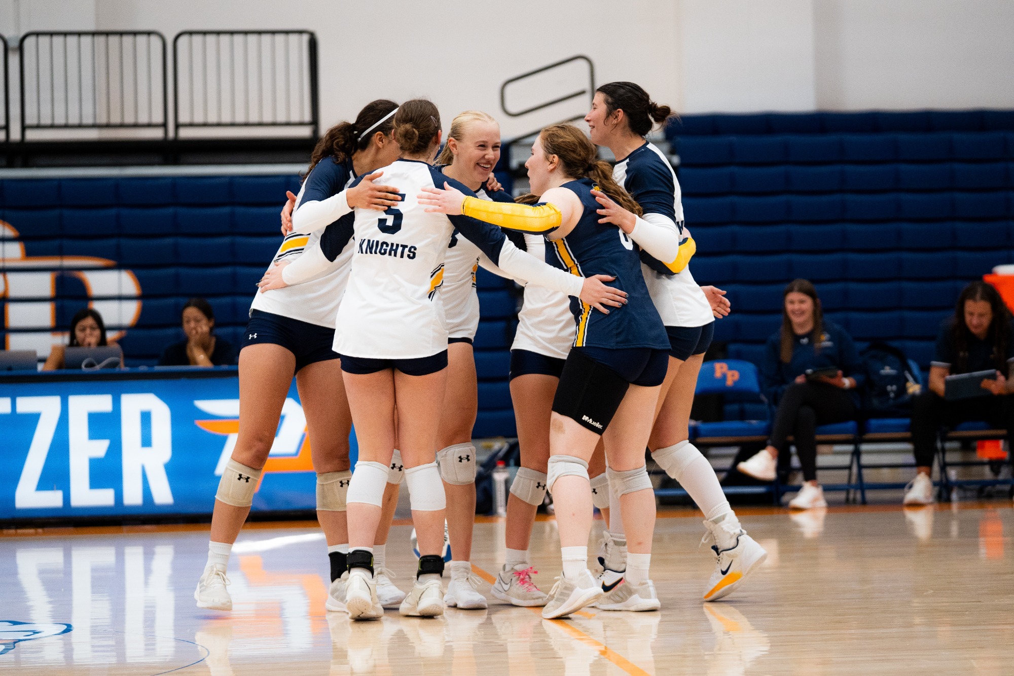 Volleyball celebrates a point with a team huddle
