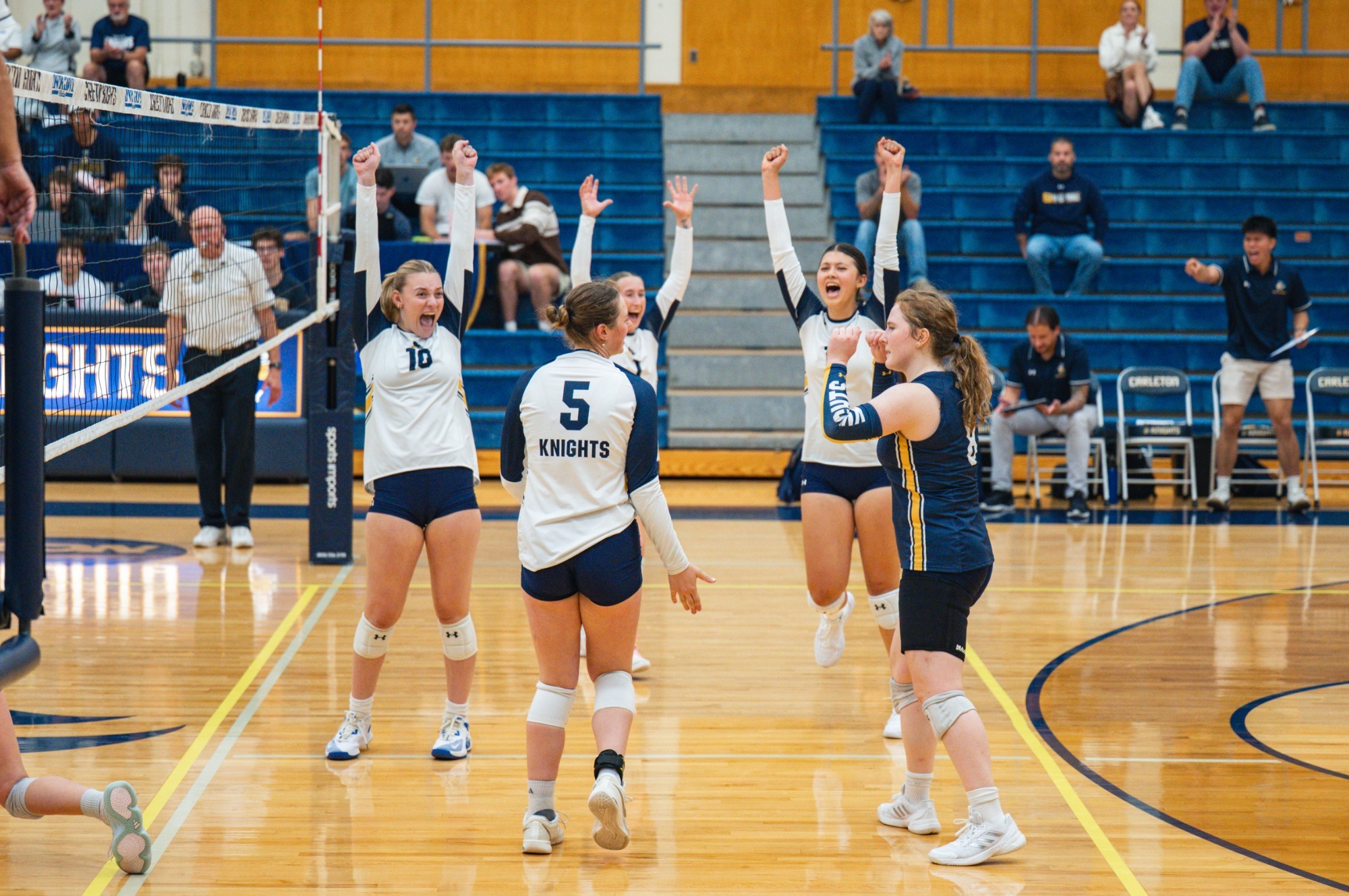 Carleton volleyball celebrates a point at West Gym in a win over Crown