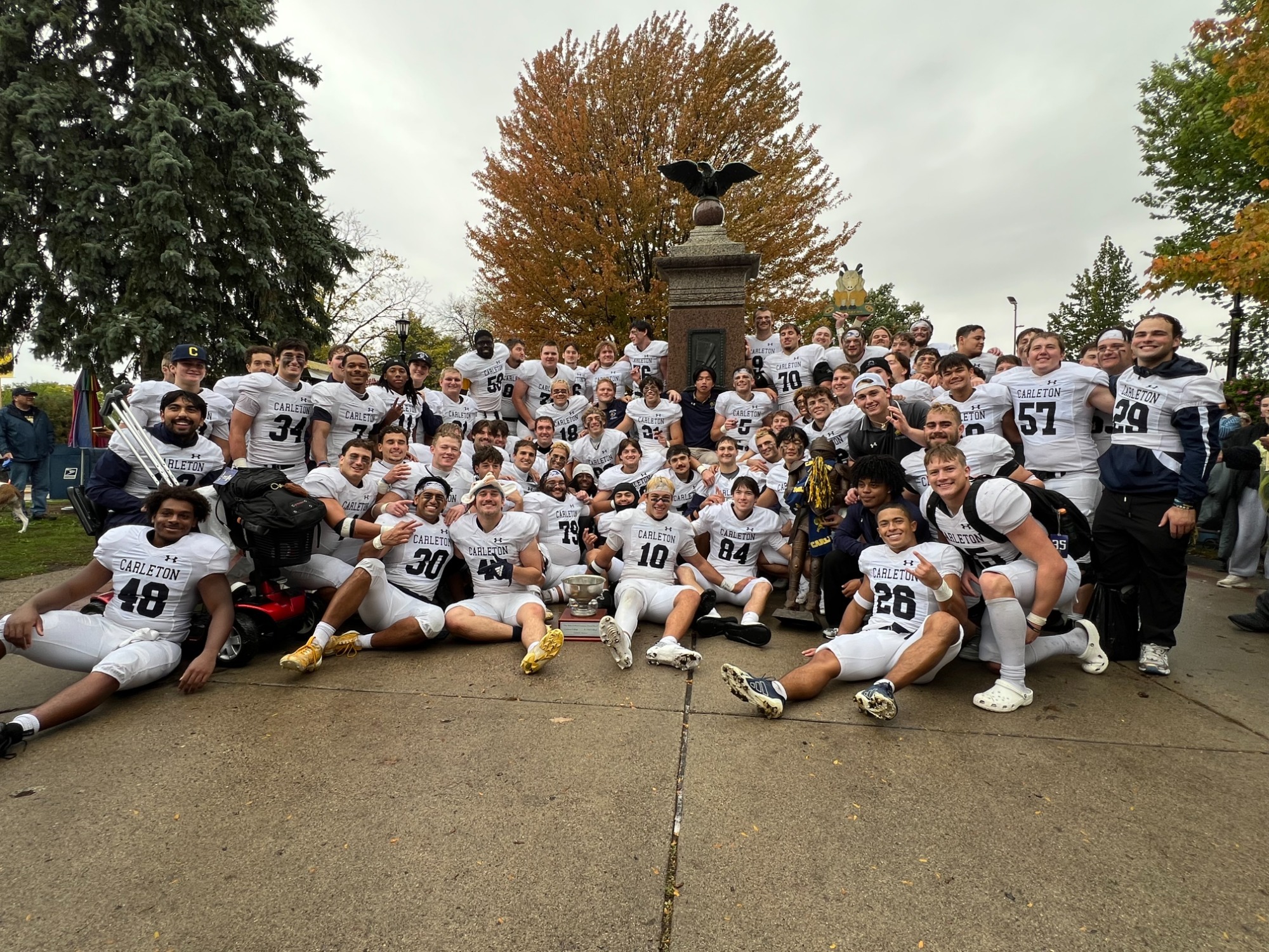 Carleton football players celebrate in Bridge Square after defeating St. Olaf