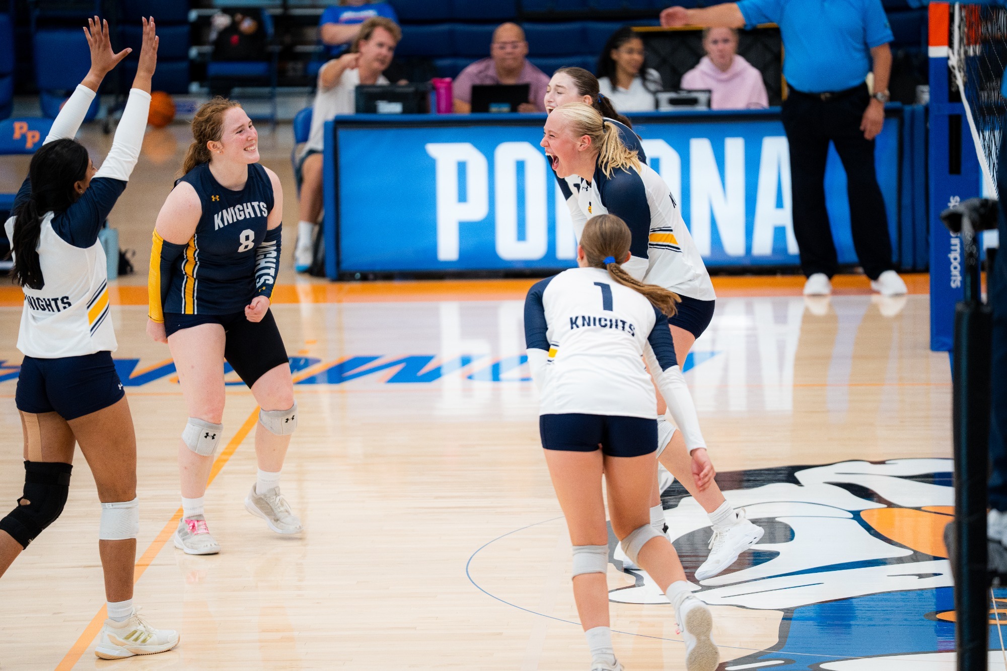 The volleyball team celebrates a point at the Pacific Coast Classic