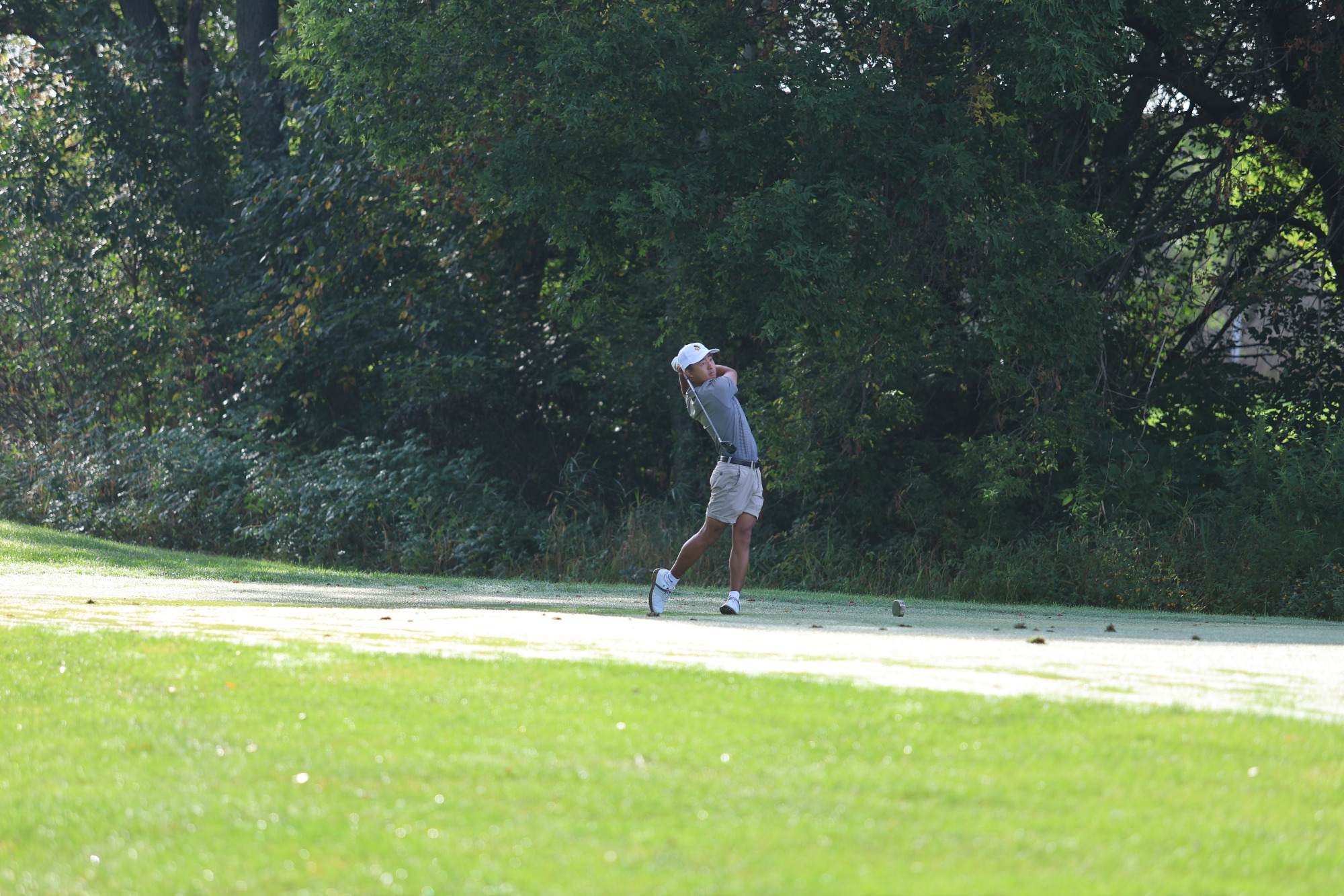 Sam Higaki hitting a tee shot