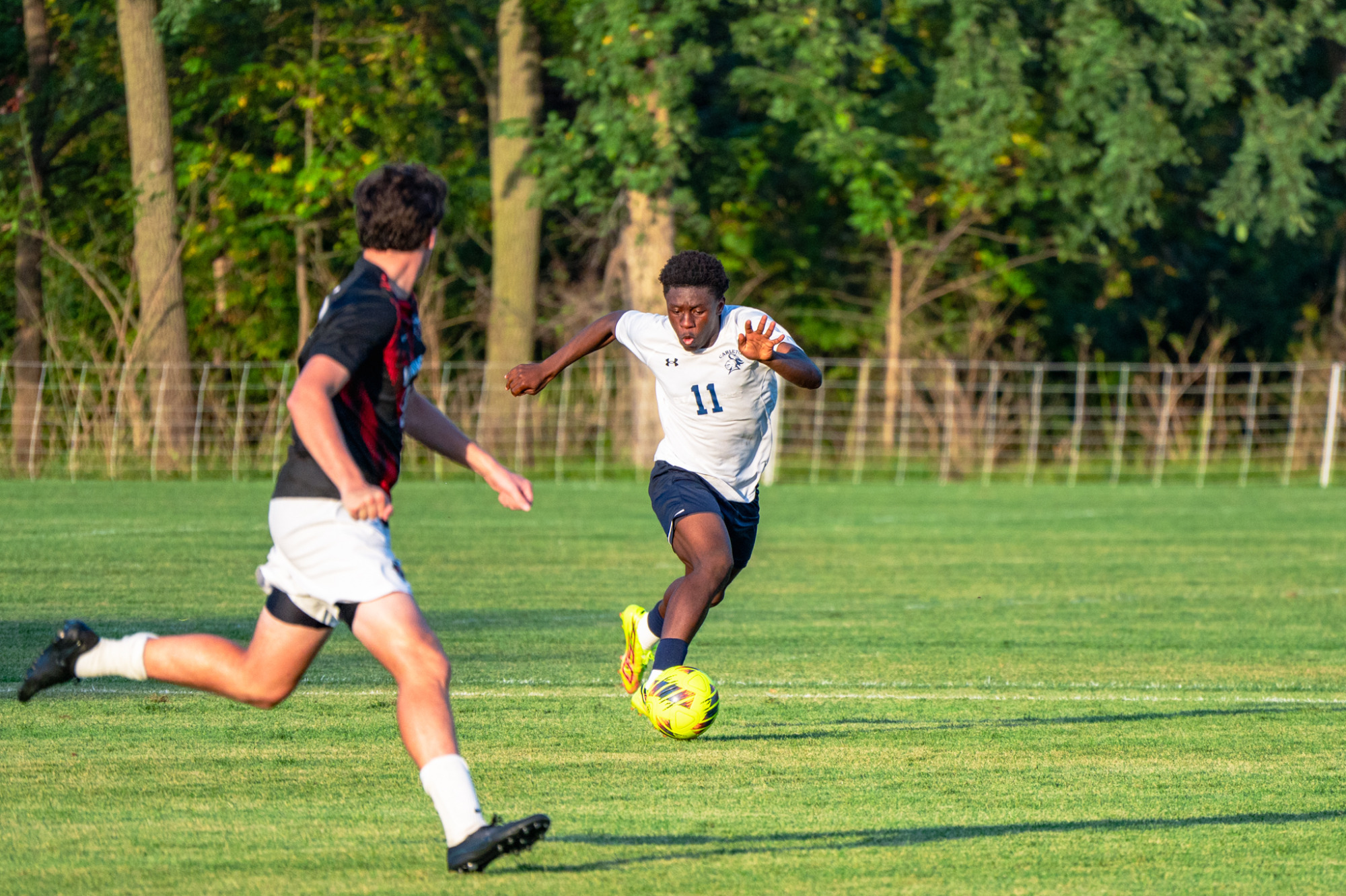 Matthew Deffo dribbles the ball up field