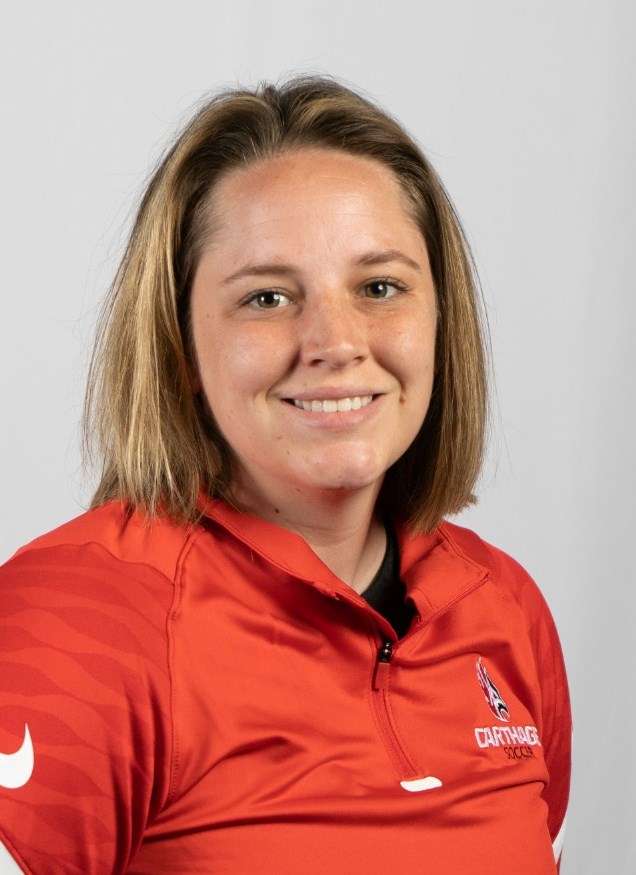 Meagan DeGroot smiling for their women's soccer headshot, wearing a red Carthage top.