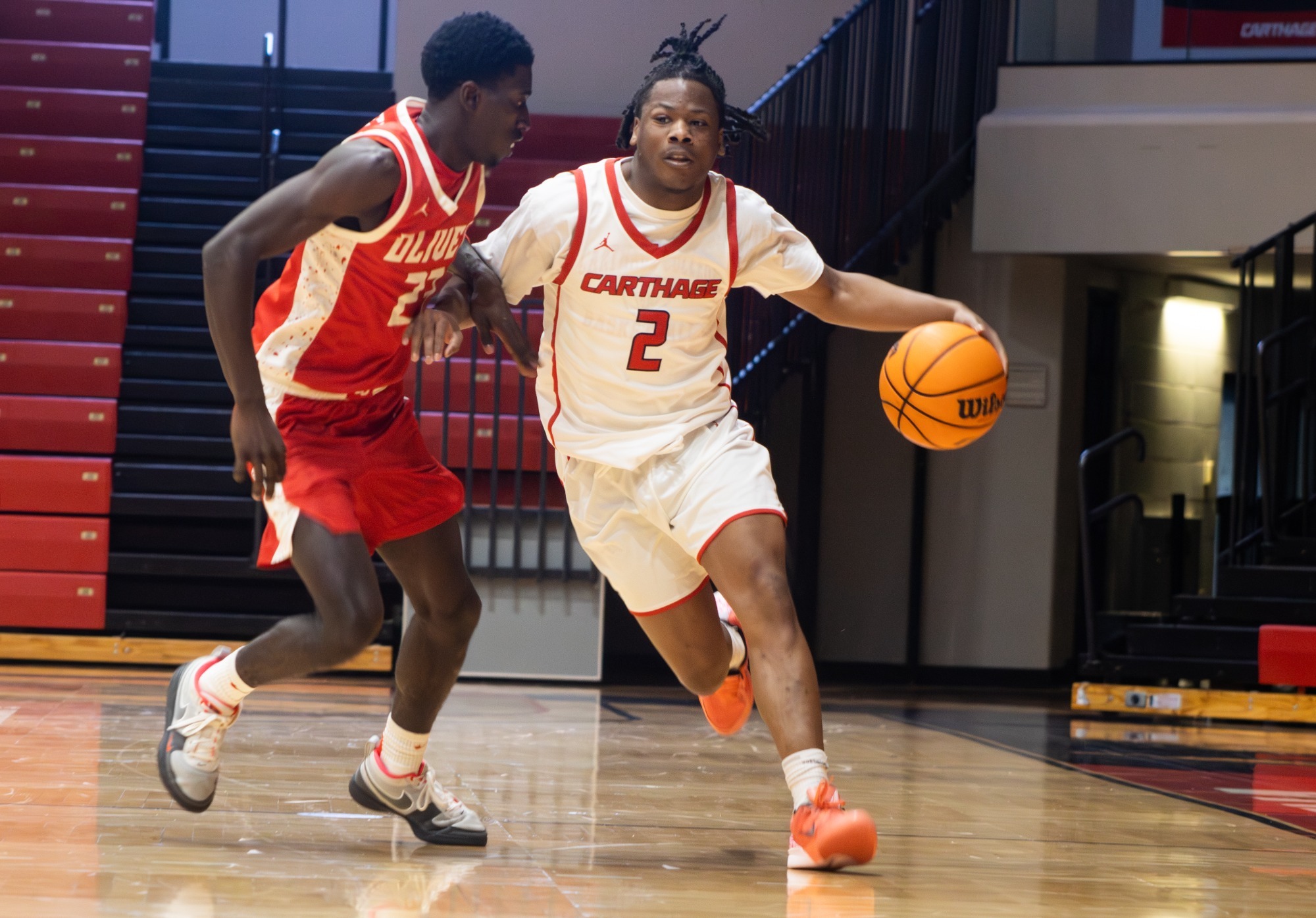 Jalen Brown dribbles the ball up court against Olivet