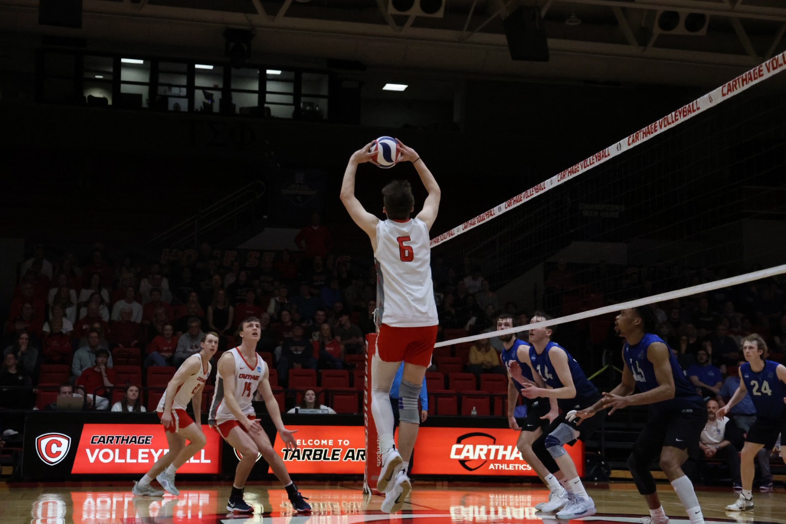 Ryan Morey sets the ball to a teammate during their game against Aurora