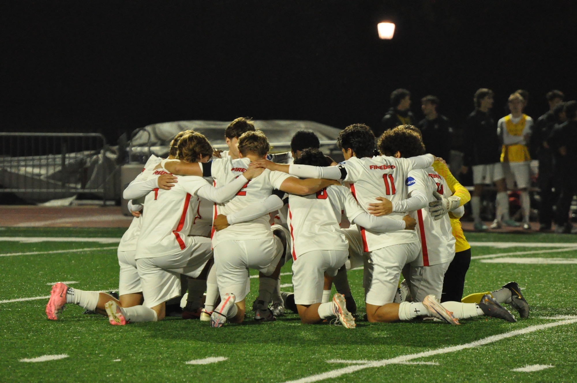 Men's soccer team gathers before kickoff