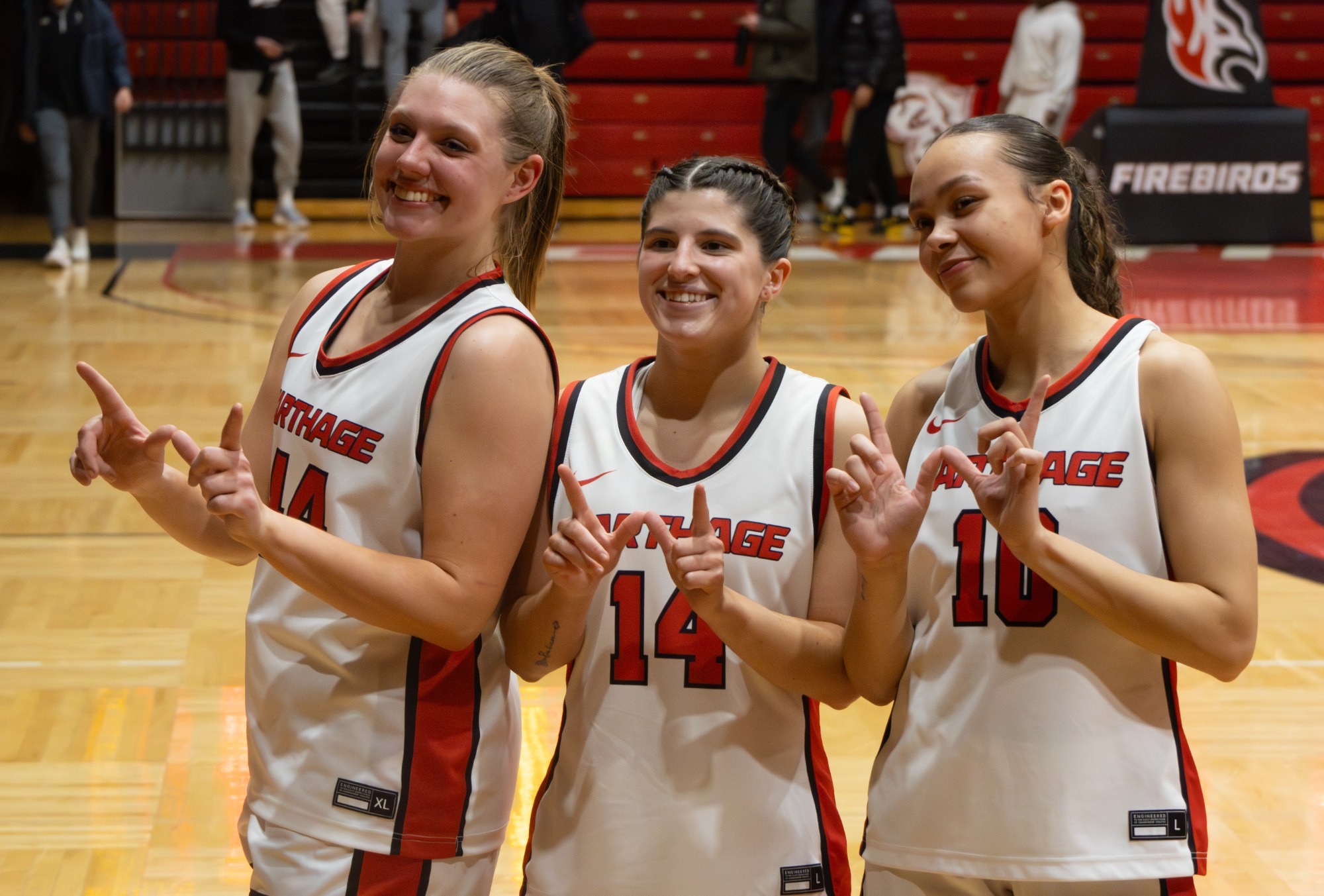 Cord-Elsmore-Green pose following win over Elmhurst