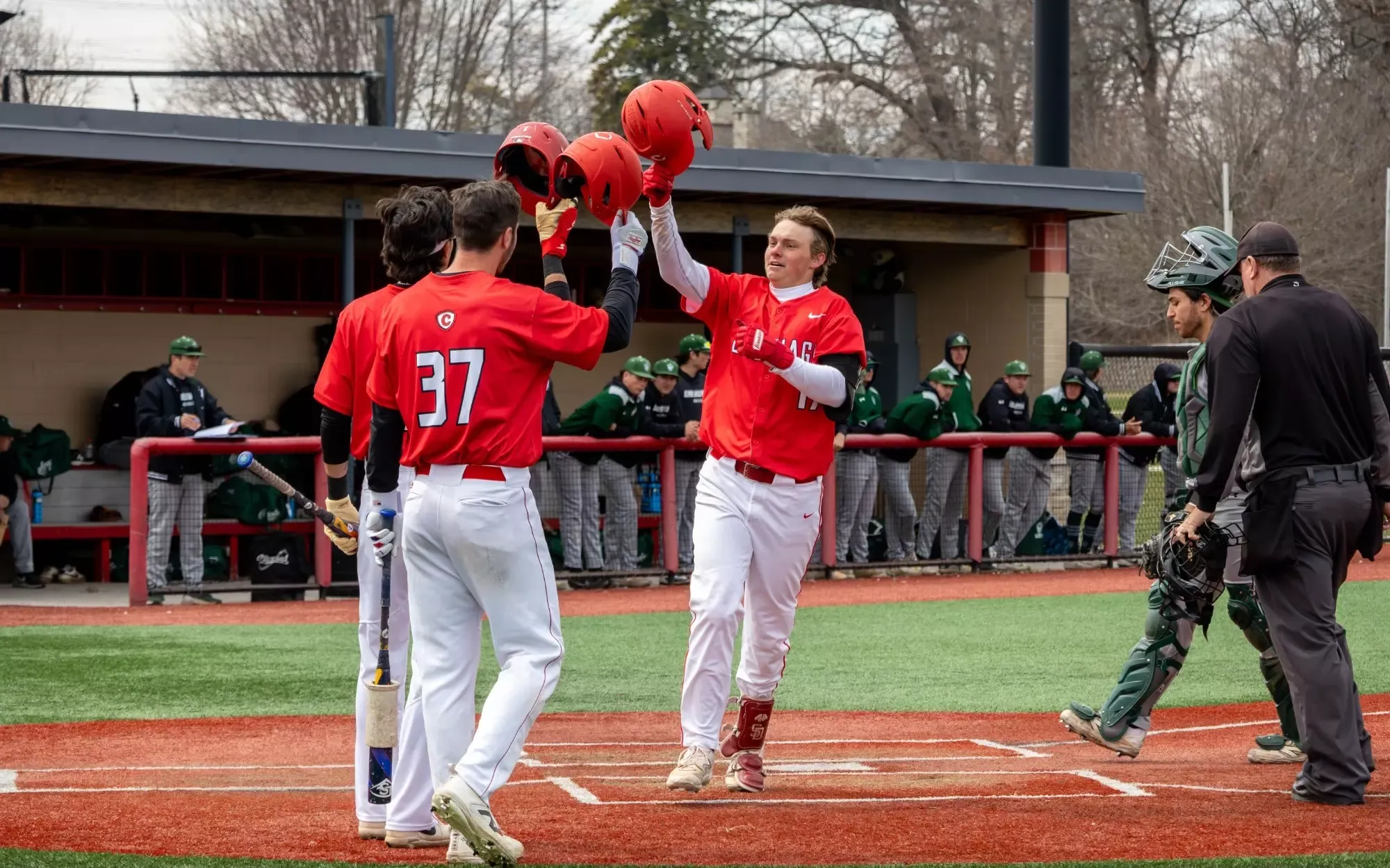 Michael Ossenfort celebrates a home run with his teammates