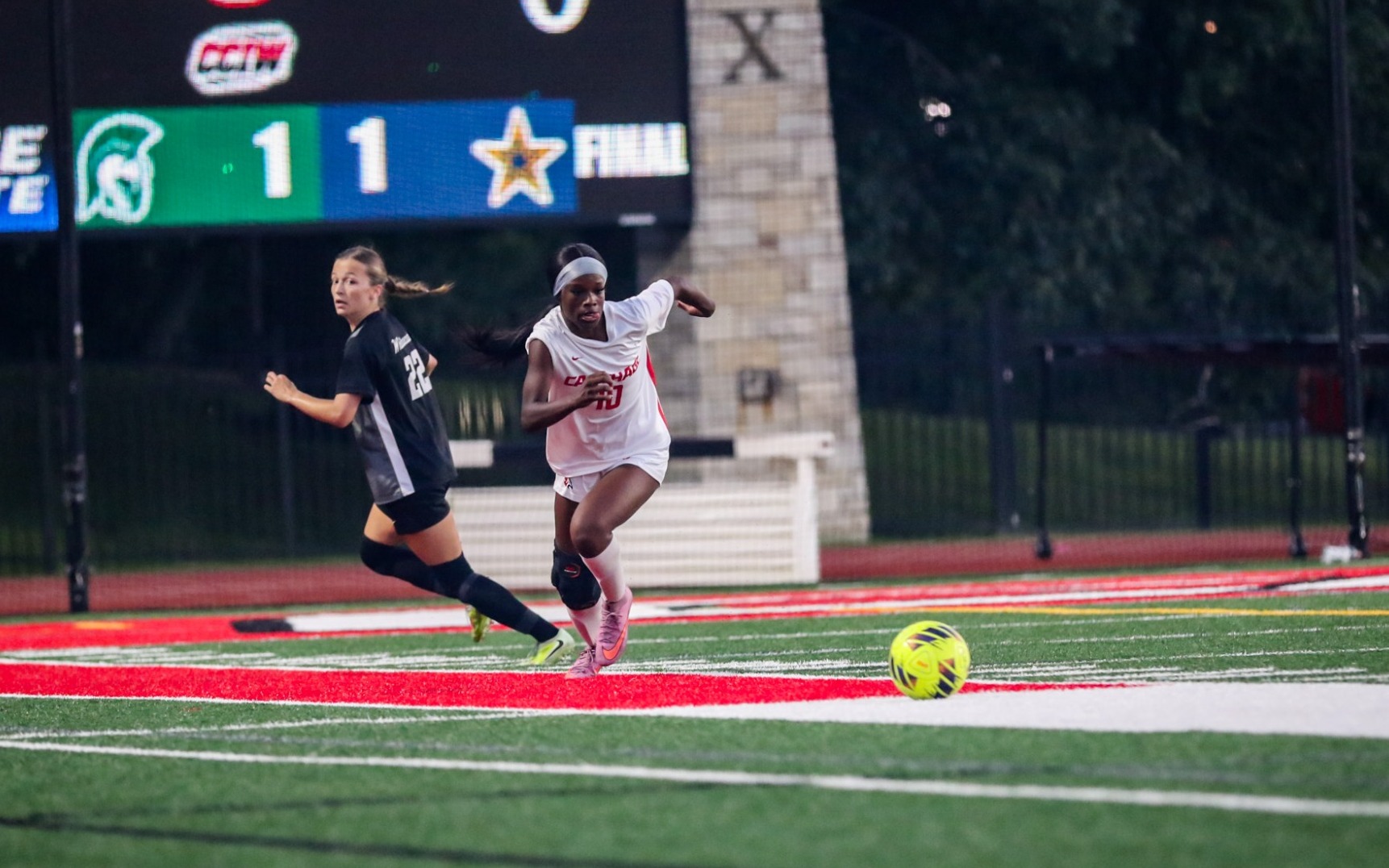 Tia Mullens dribbles the ball away from a defender
