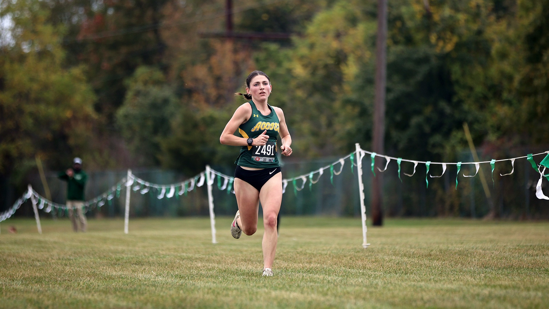 Emma East running cross country at the Green & Gold Invite