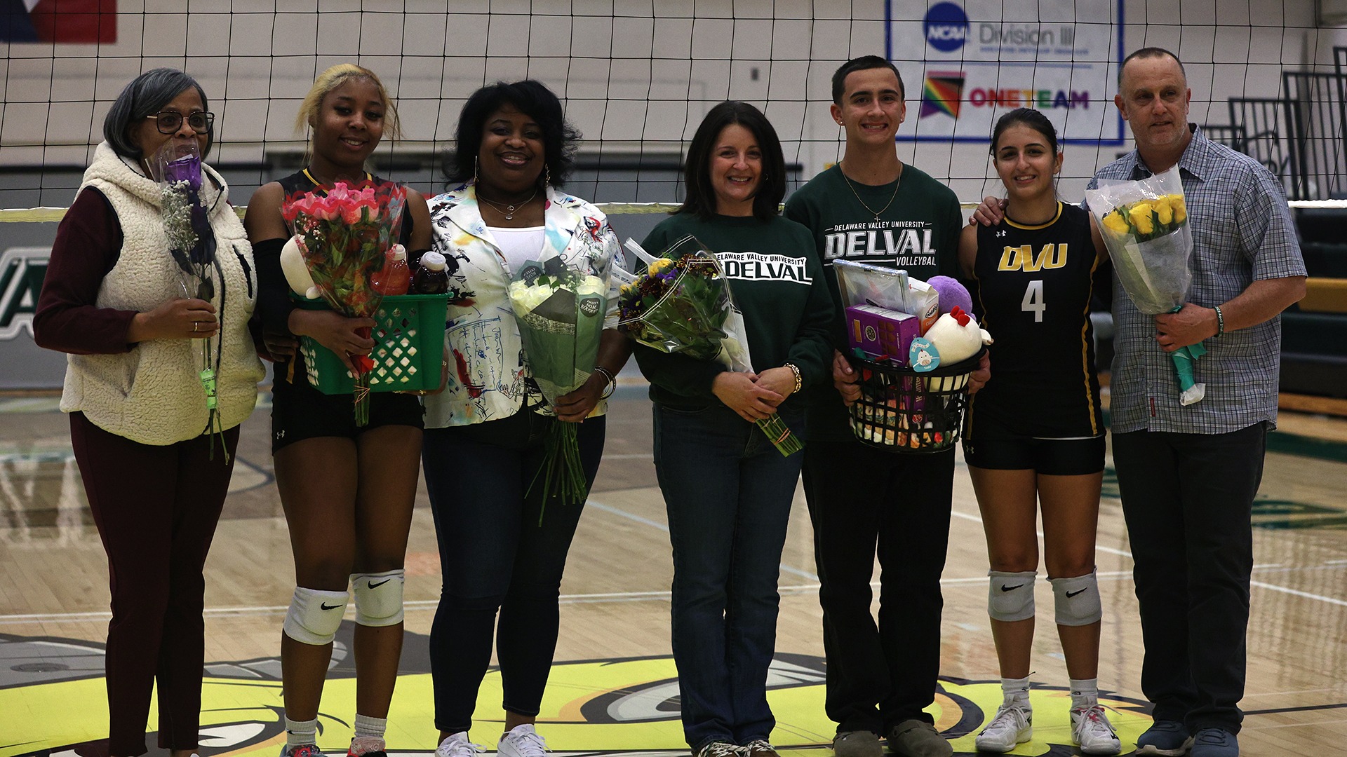 Mia Zadlo and Kai Logan with their families during senior night celebration