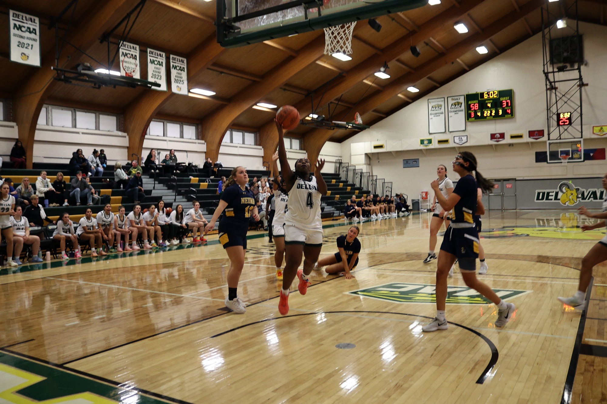 Whitney Evans playing women's basketball vs. Neumann