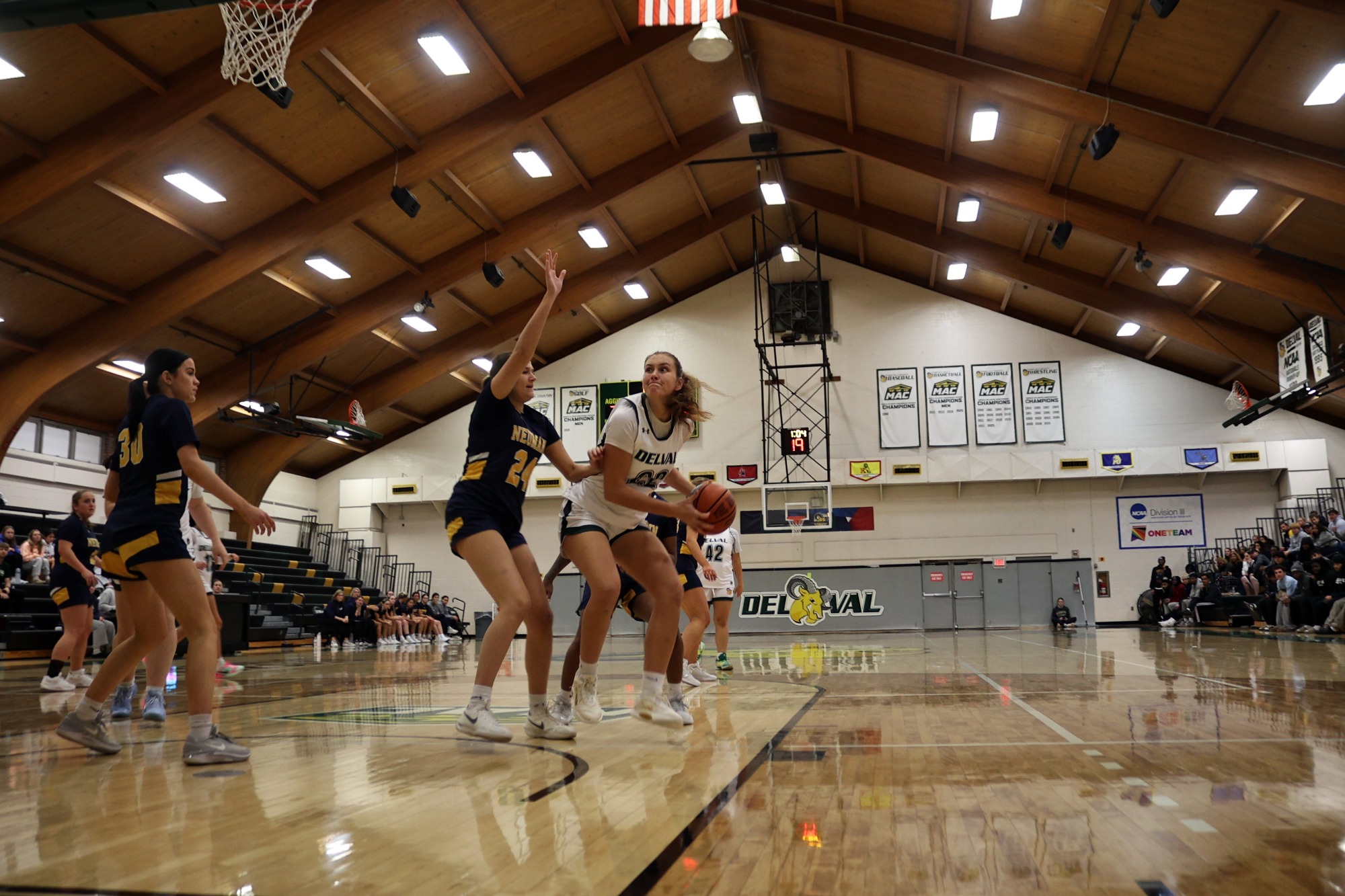 Emma Miller playing women's basketball vs. Neumann