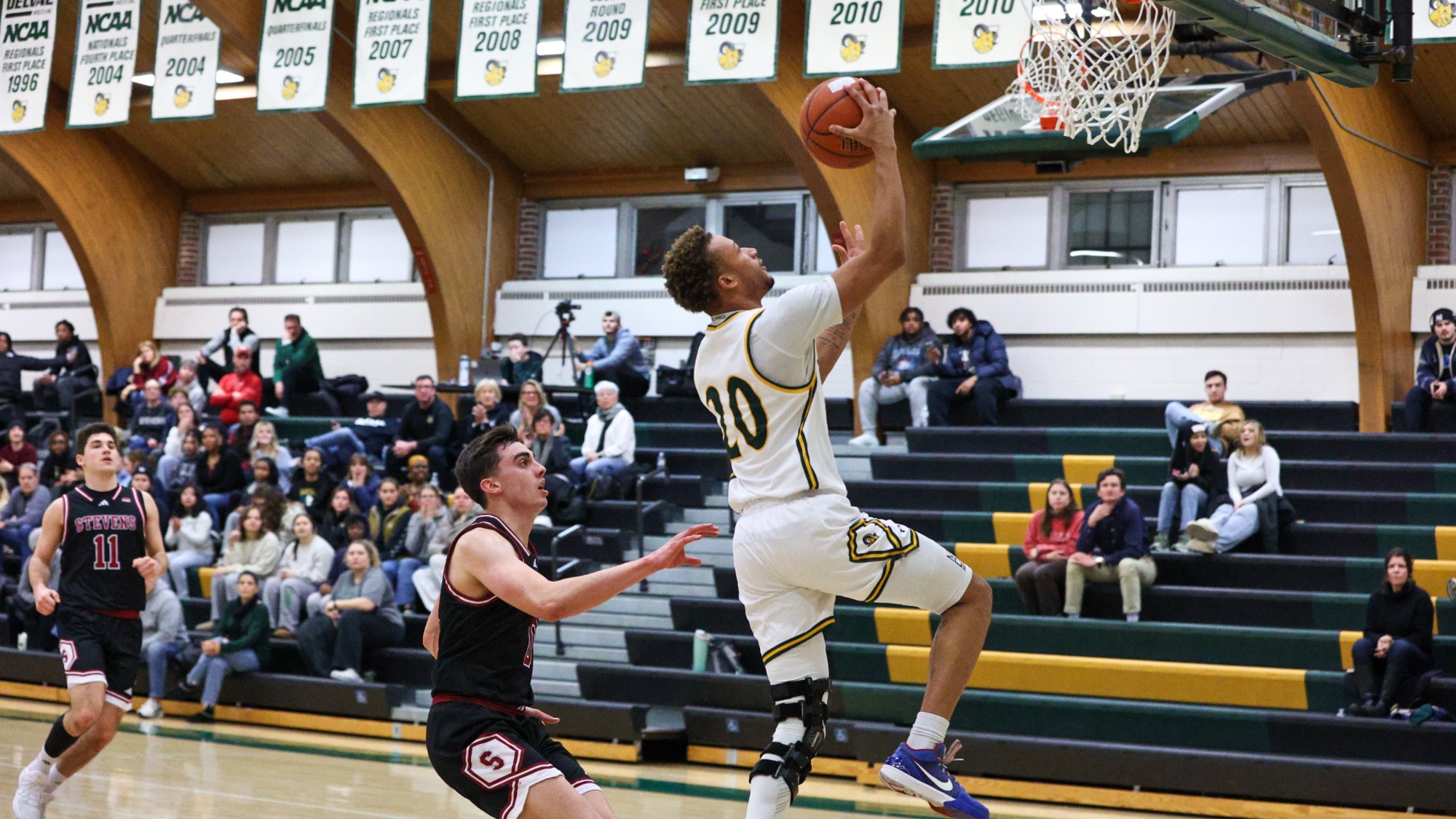 Jeremiah Lee playing basketball against Stevens IT