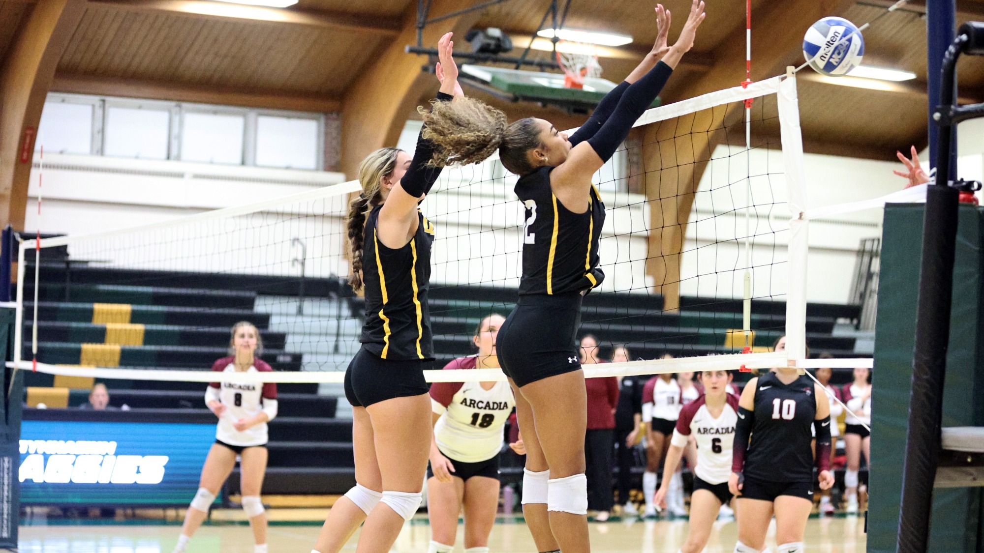 Monique Smith and Charlotte Kampf playing women's volleyball vs. Arcadia