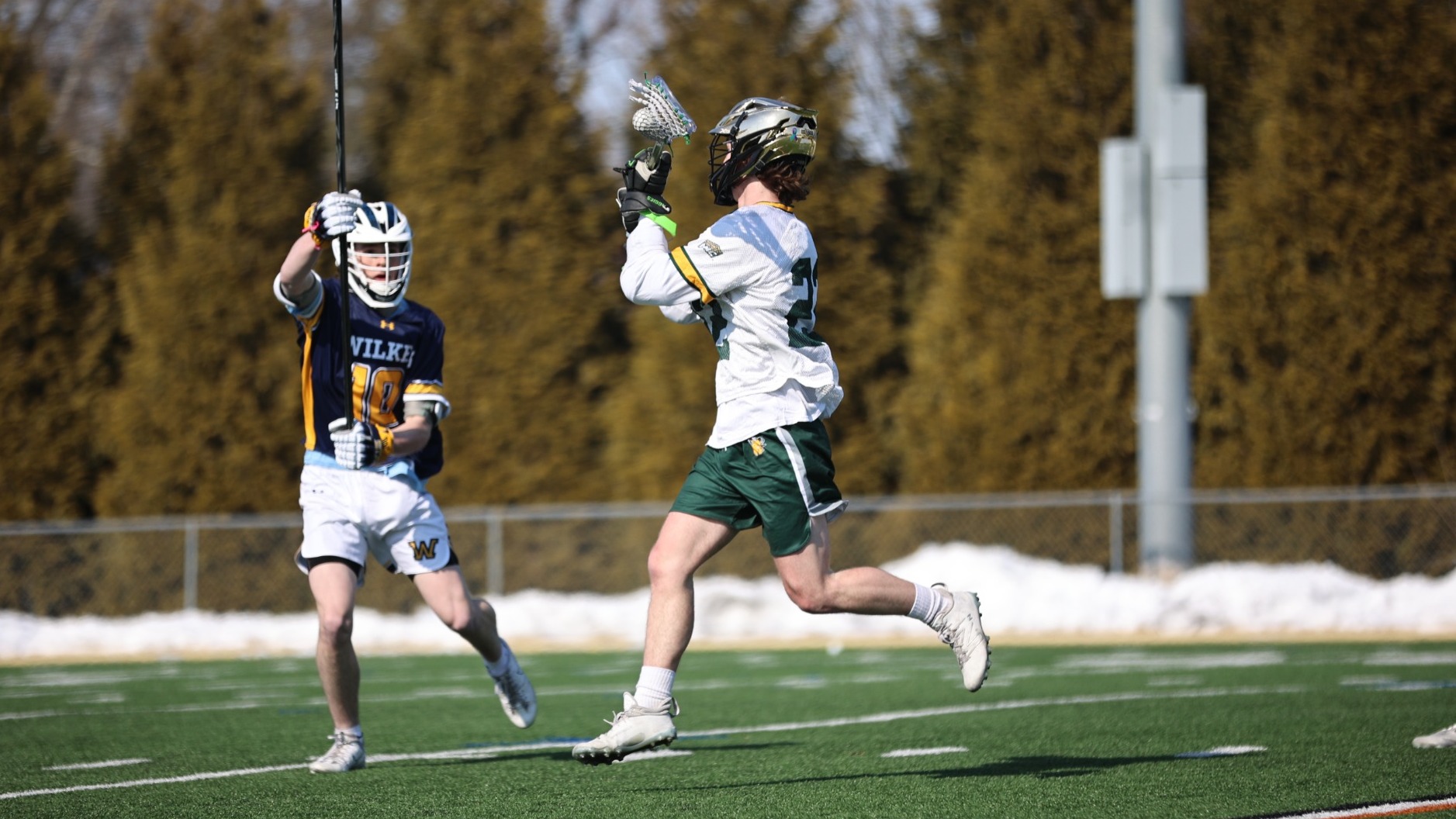 Kieran Schneider playing lacrosse vs Wilkes