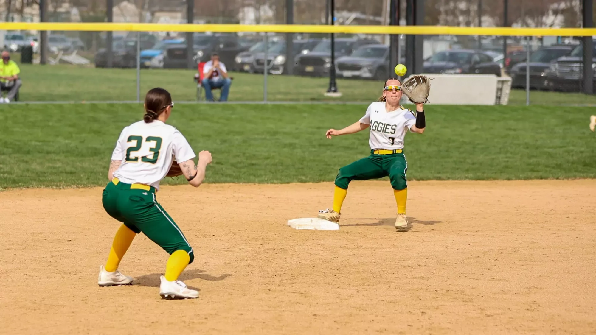 Tori Bockrath and Angelina Bresnen playing softball against Albright