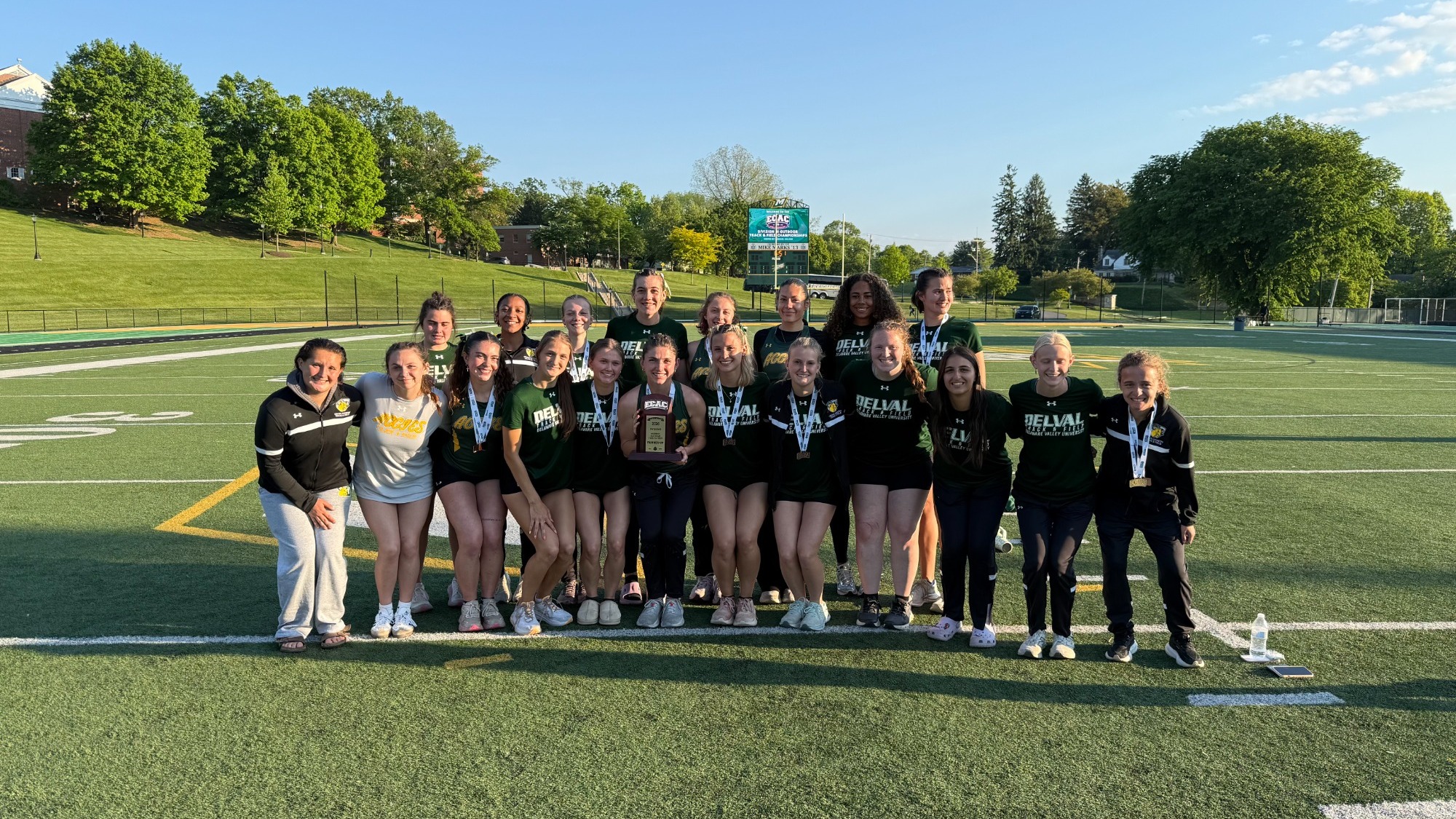 Women's track posing with second place trophy at ECAC Championships