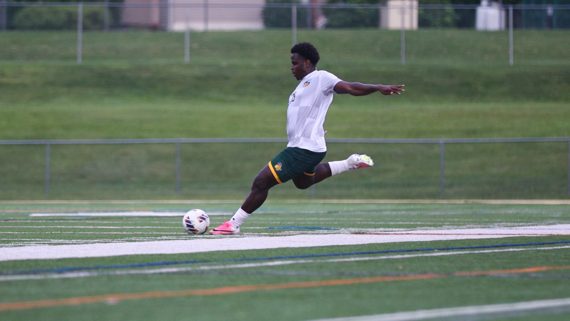 Amos Debah playing soccer against Lehman