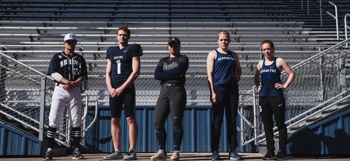 Bruin athletes stand in front of the Stoffer Family Stadium grandstands