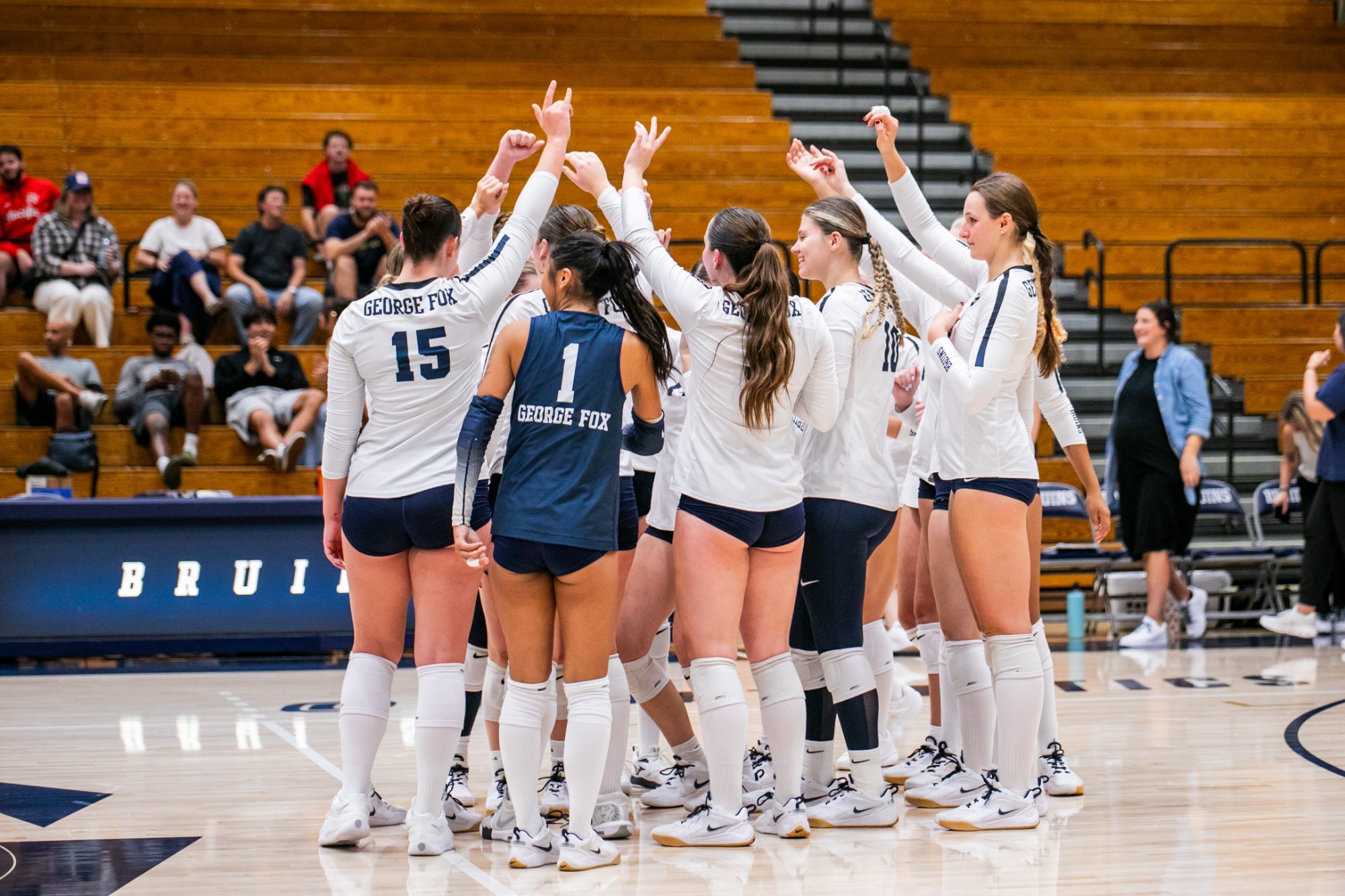Women's Volleyball team huddles together
