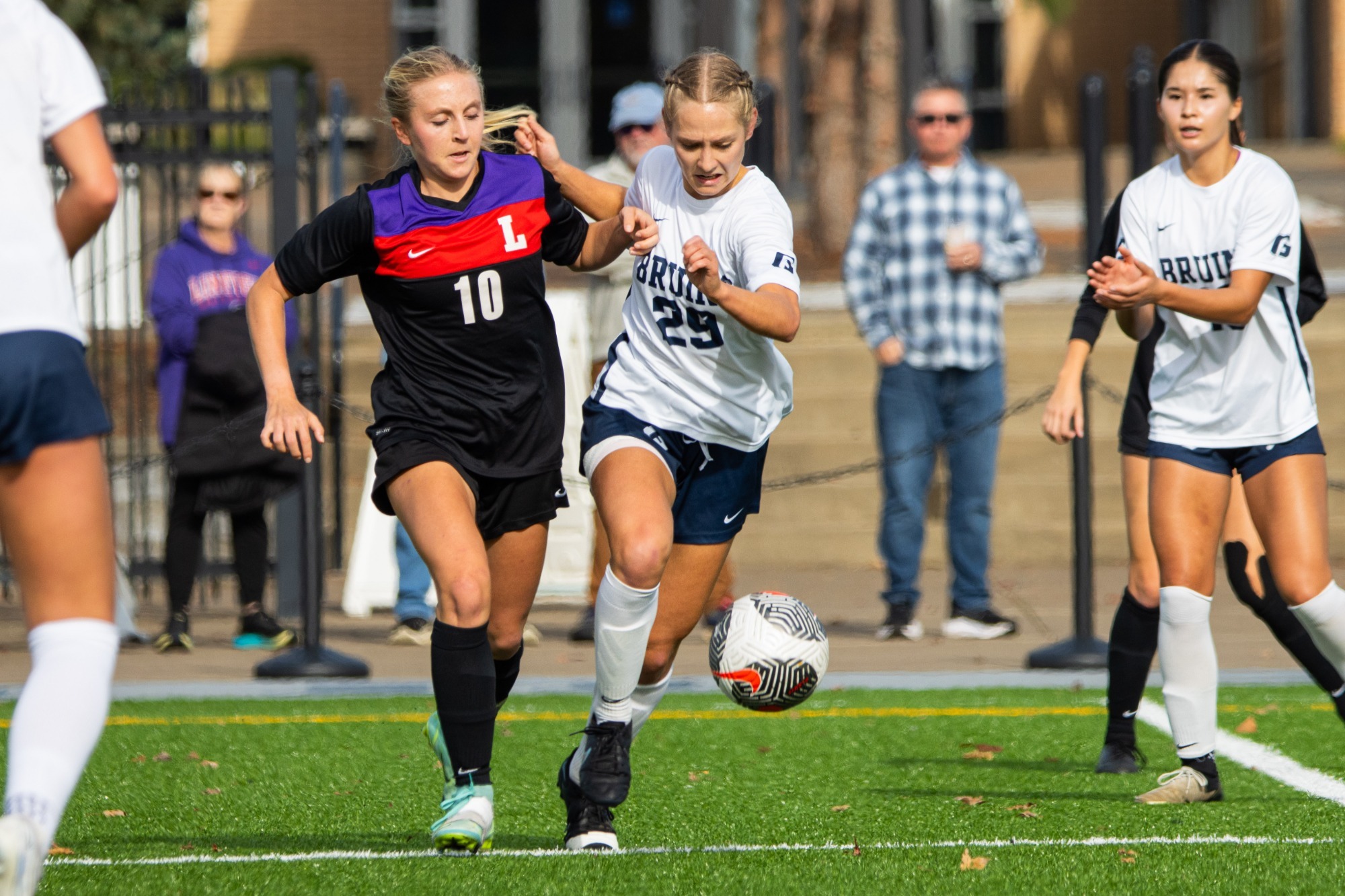Isabelle Carrington dribbling ball next to defender 