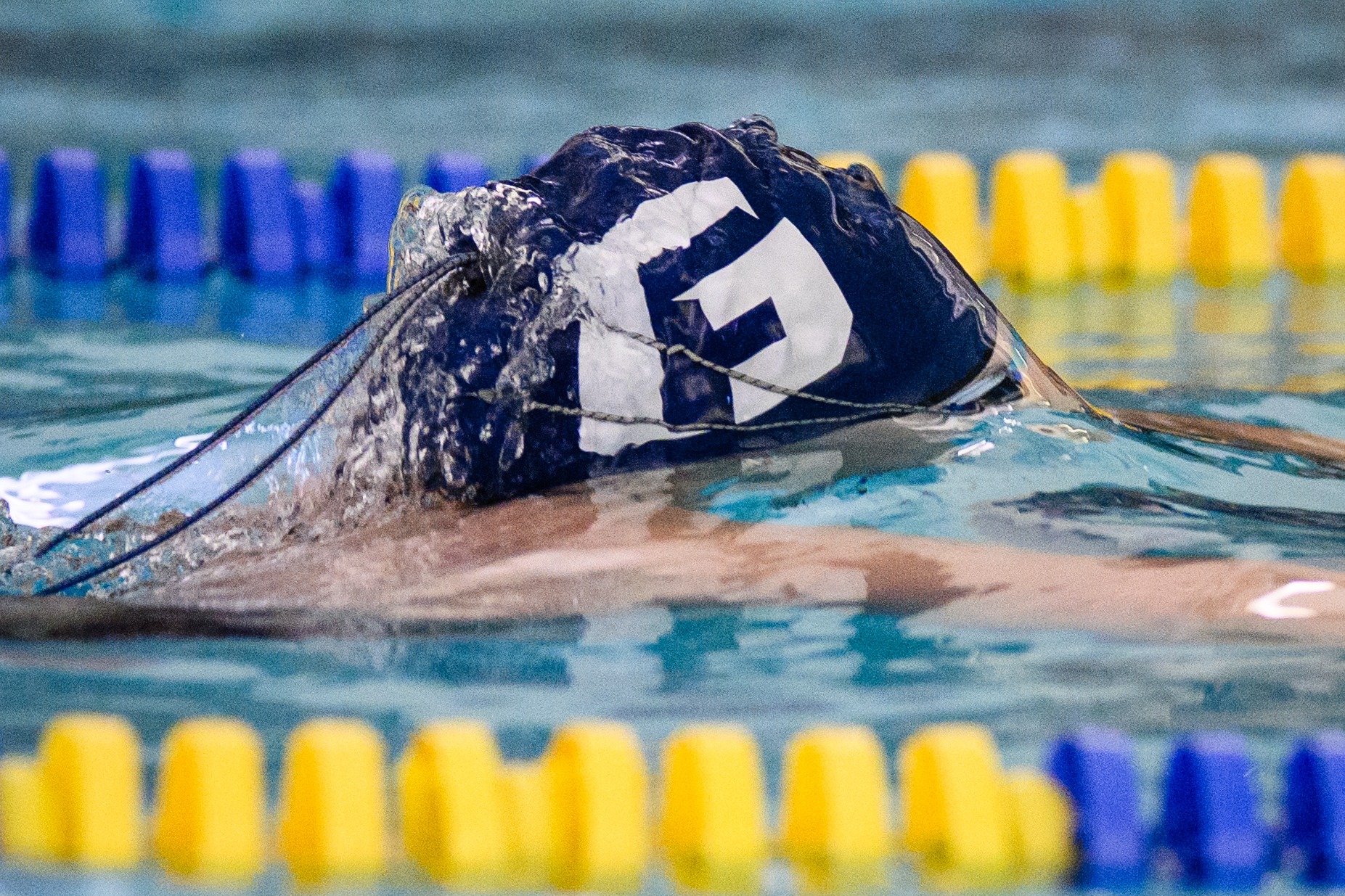 Swimmer with swim cap above water