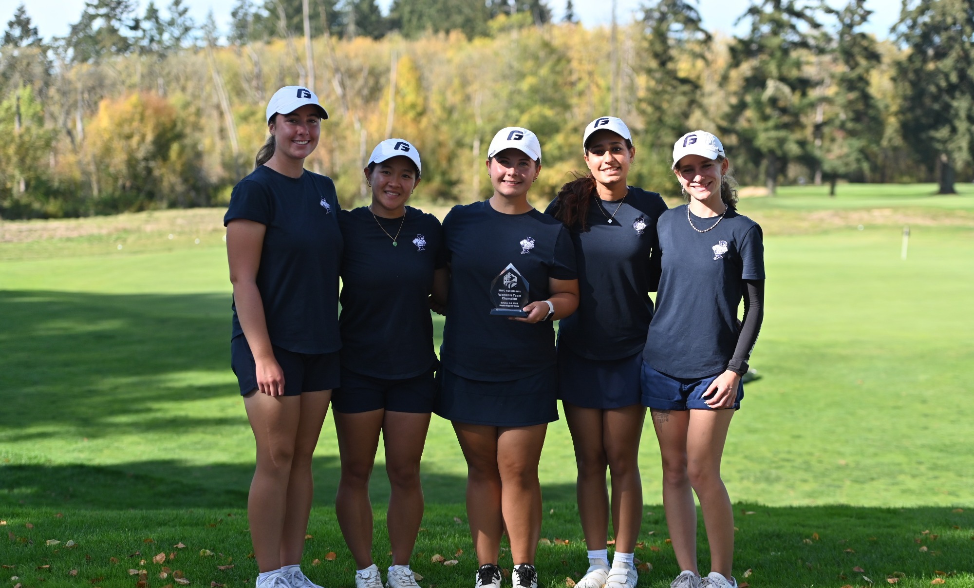 Women's team holding NWC Fall Classic Trophy