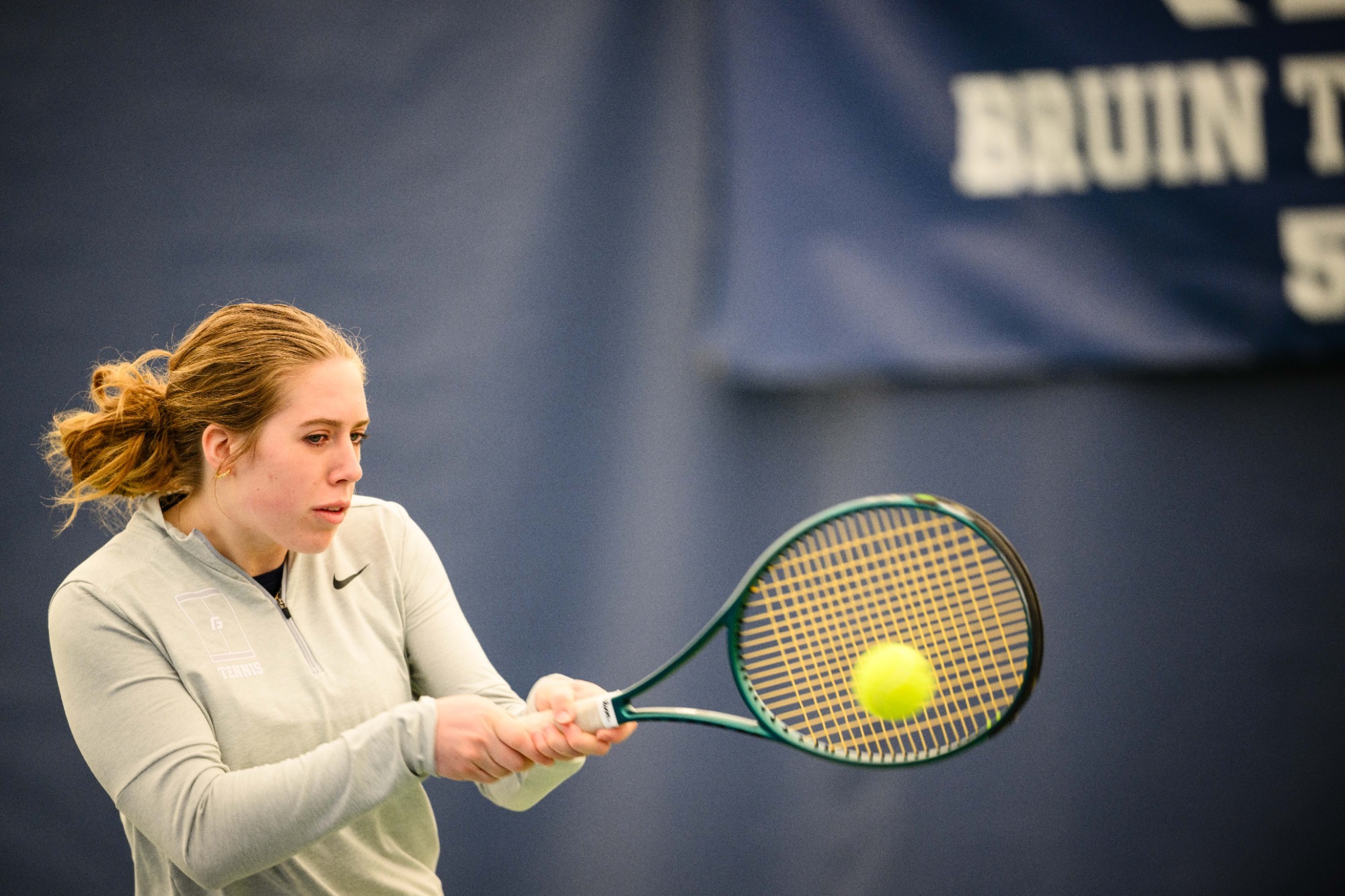 Juhree Kizziar swinging at tennis ball