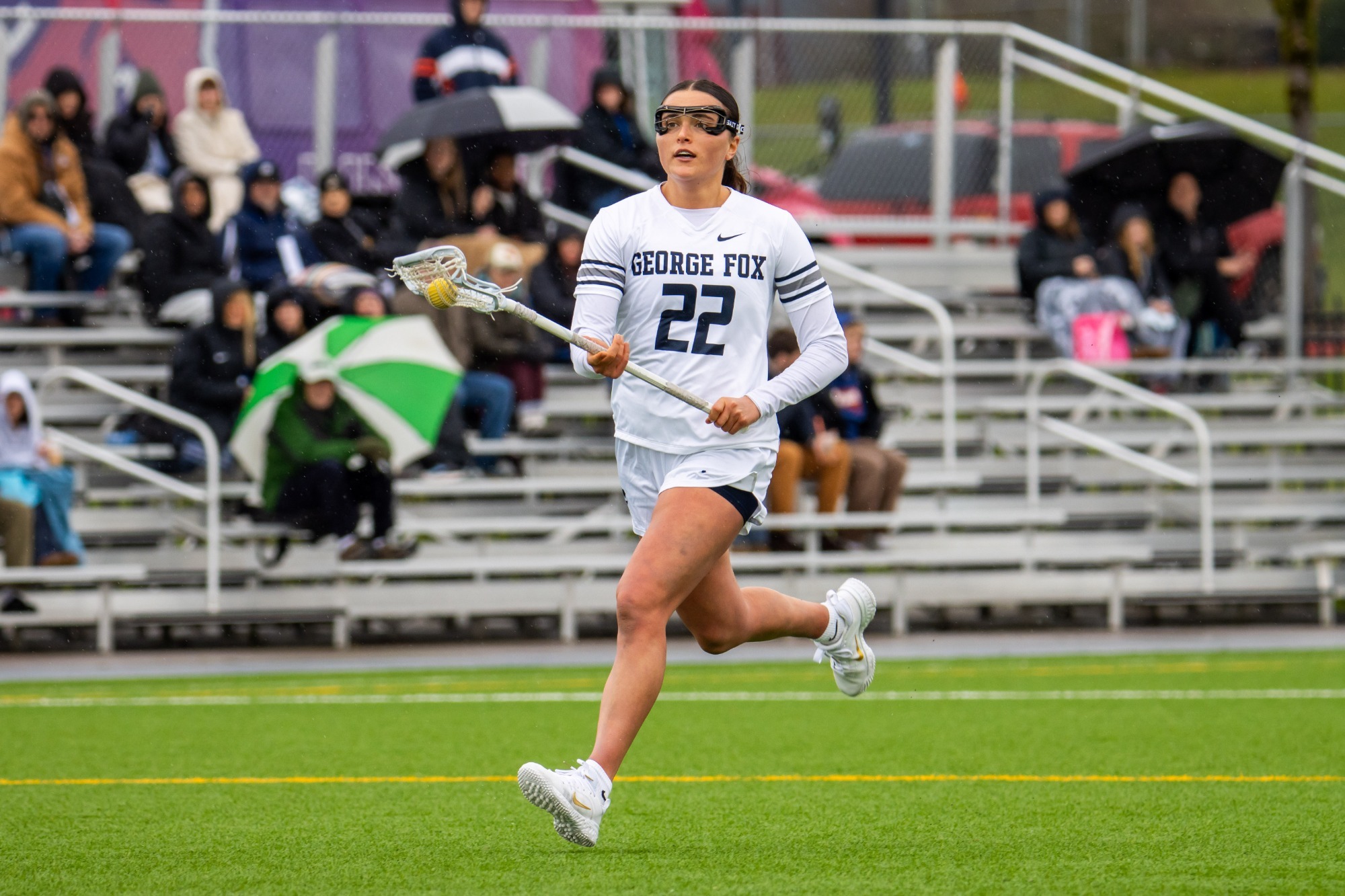 Lana Davis in motion with ball in lacrosse stick