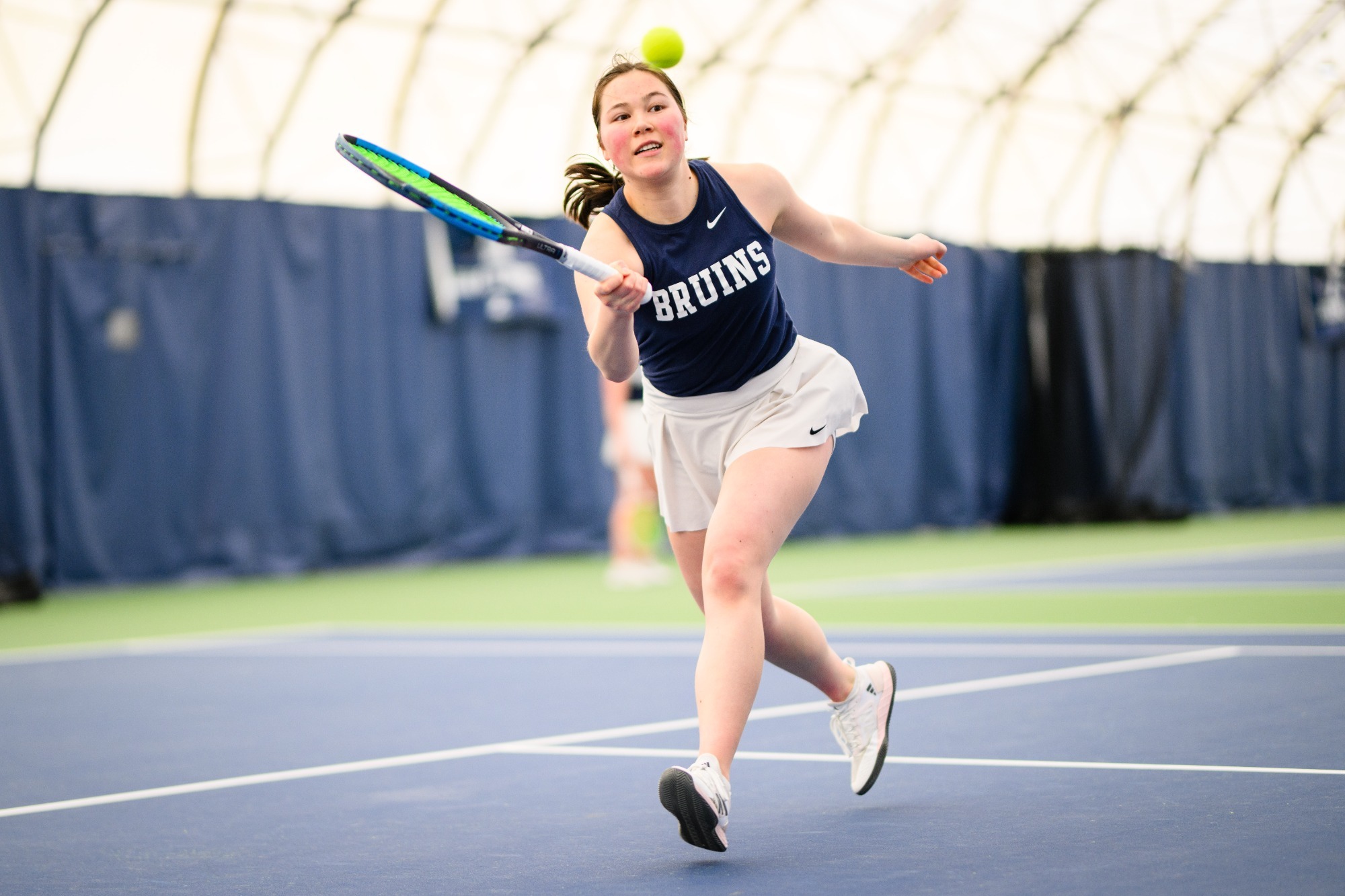 Shanah Denham reaching for a ball with racket