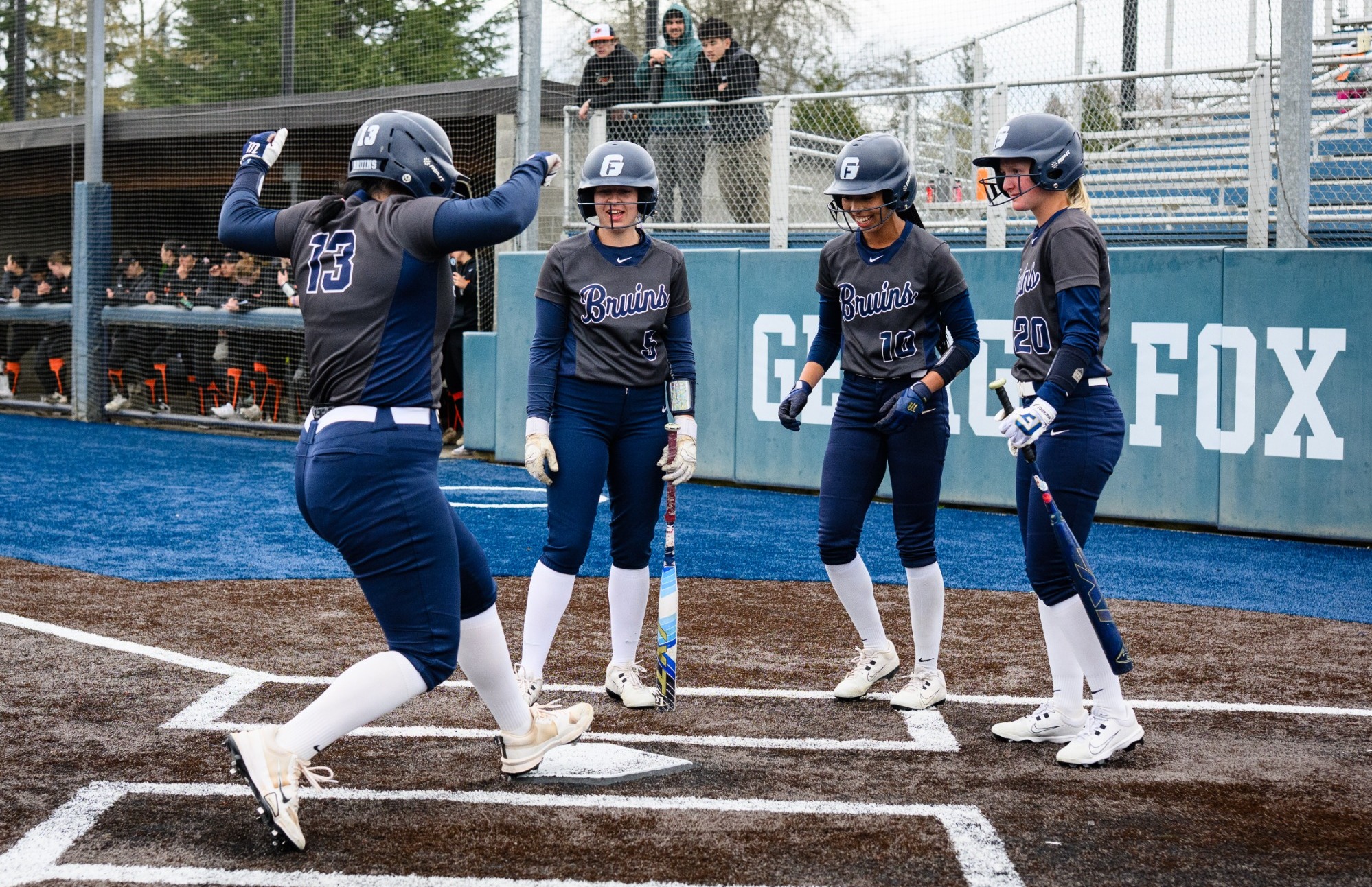 Corine Doran steps on home base after home run 