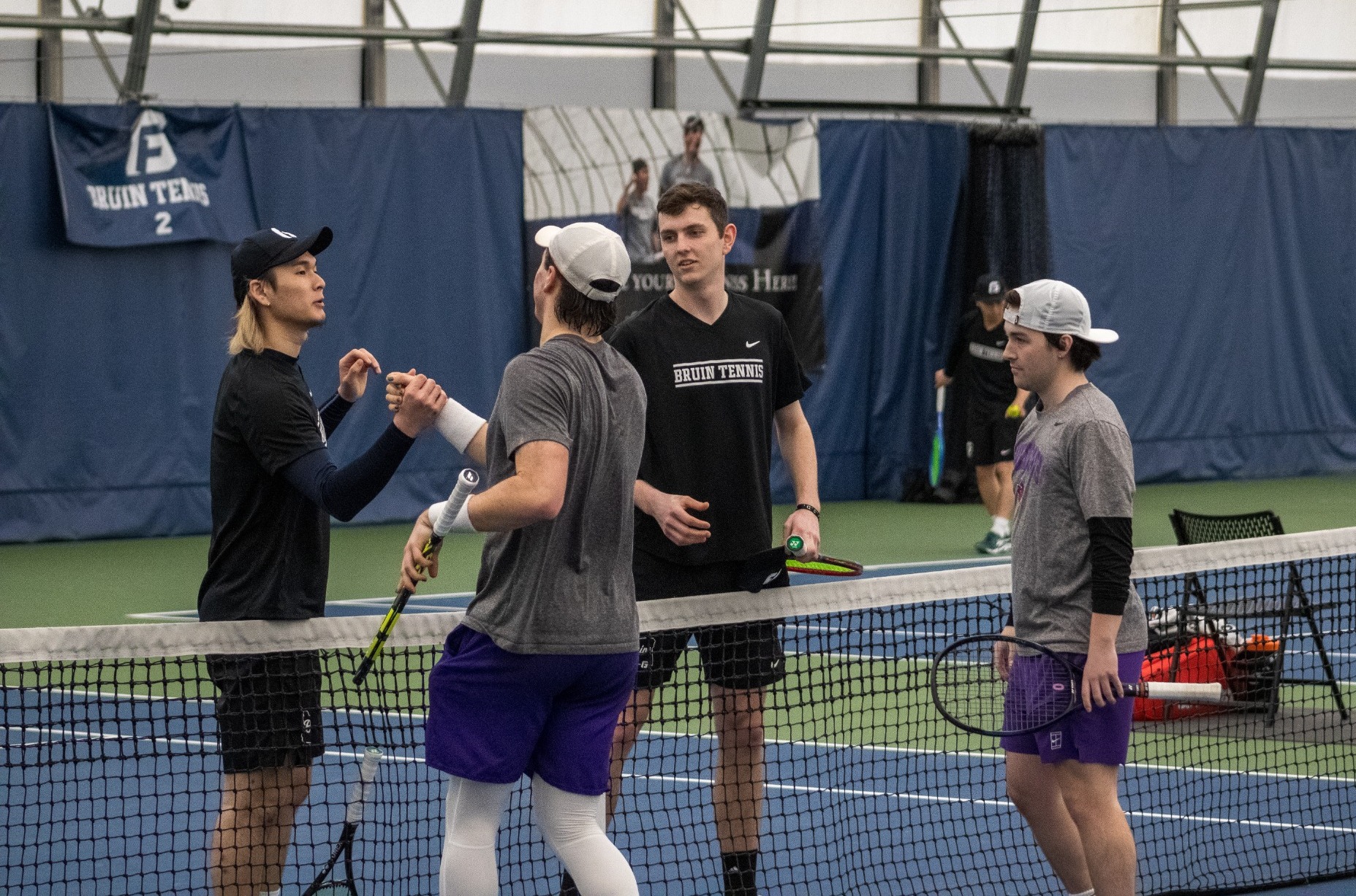 Zach Moore and Ikuho Ebisu shaking hands with opponent after match
