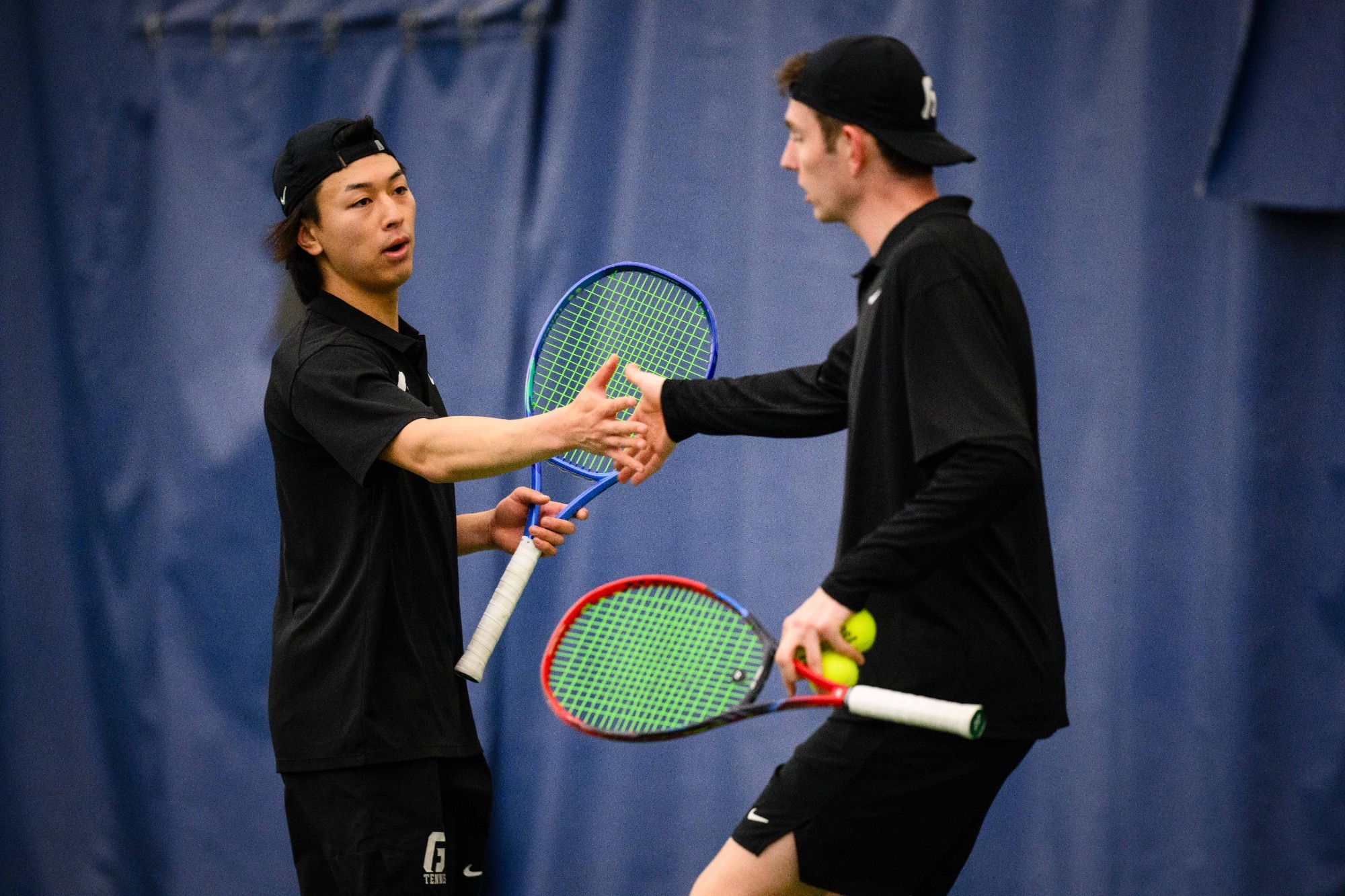 Bruins playing doubles tennis