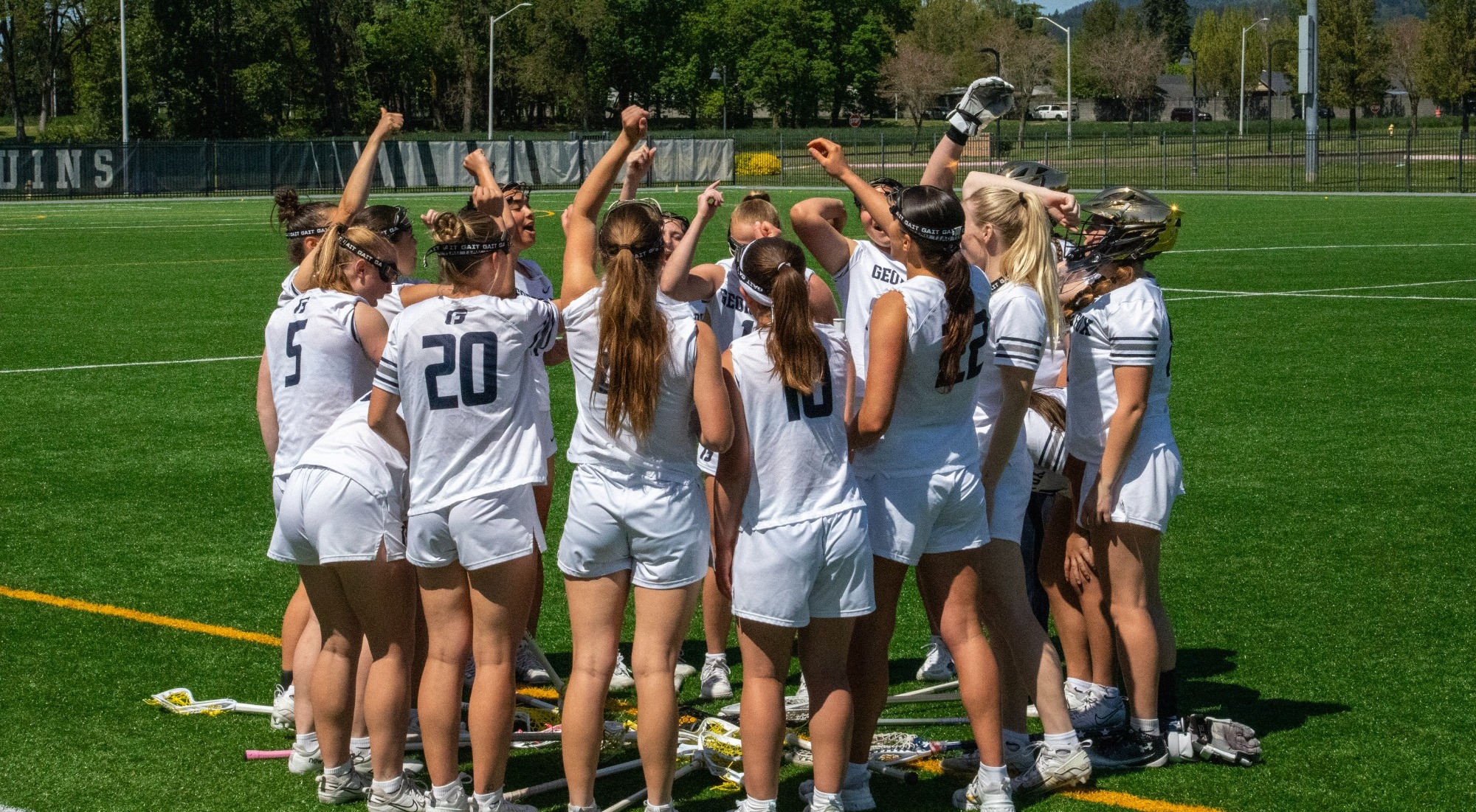 Team huddle with hands in air
