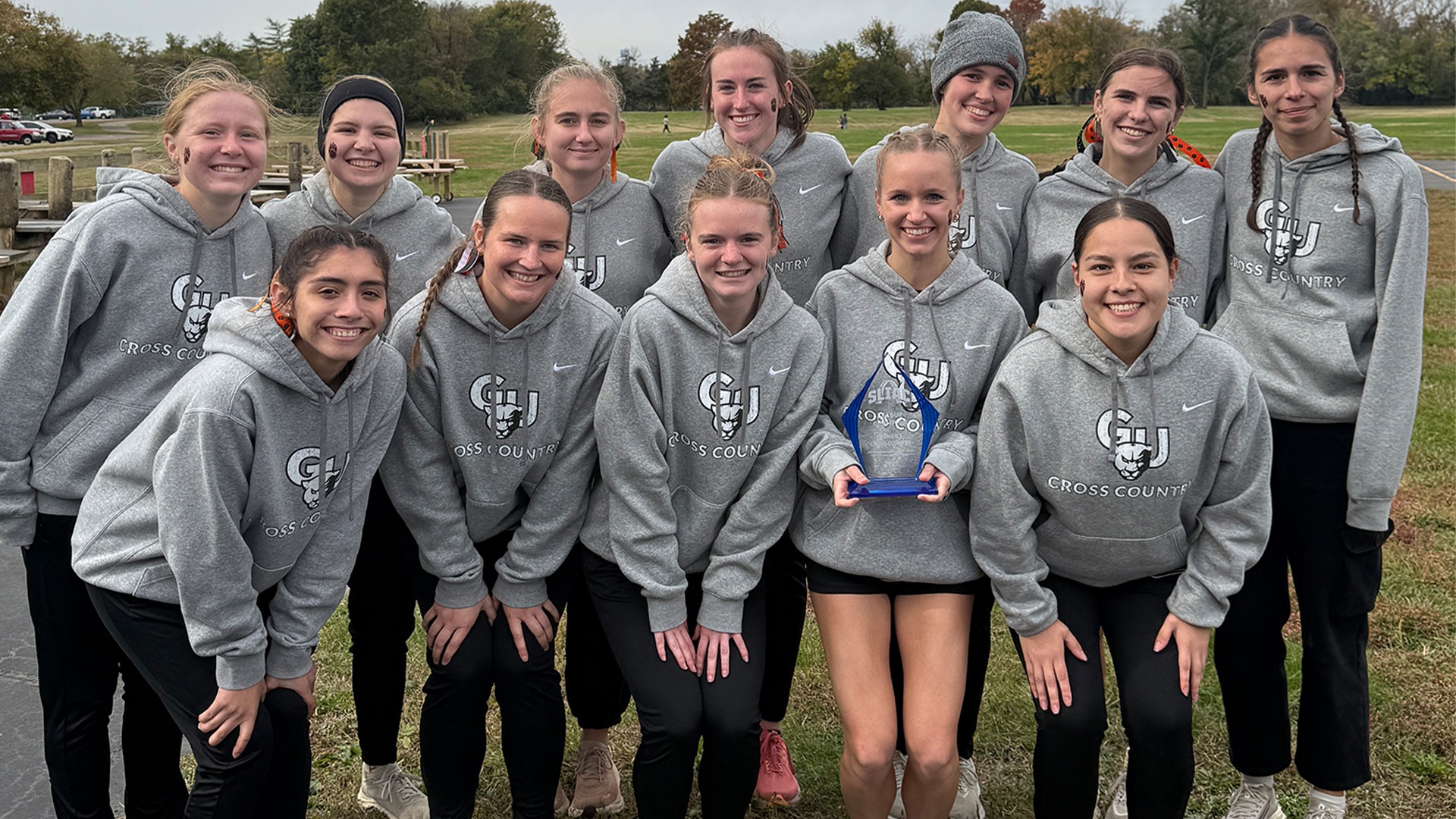 Team picture holding conference award after winning SLIAC Championship