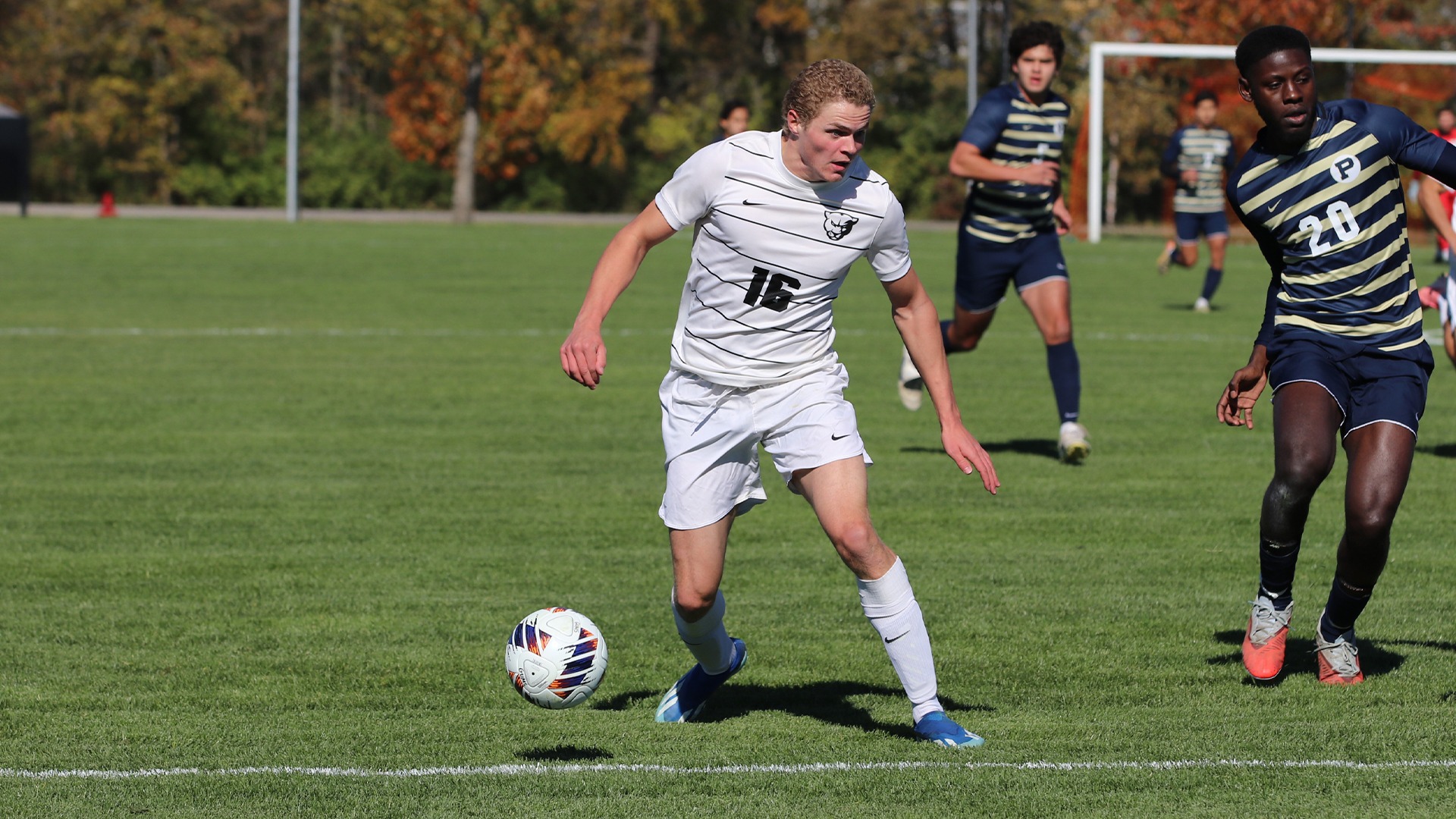 William Carlson Webb in white jersey dribbling ball