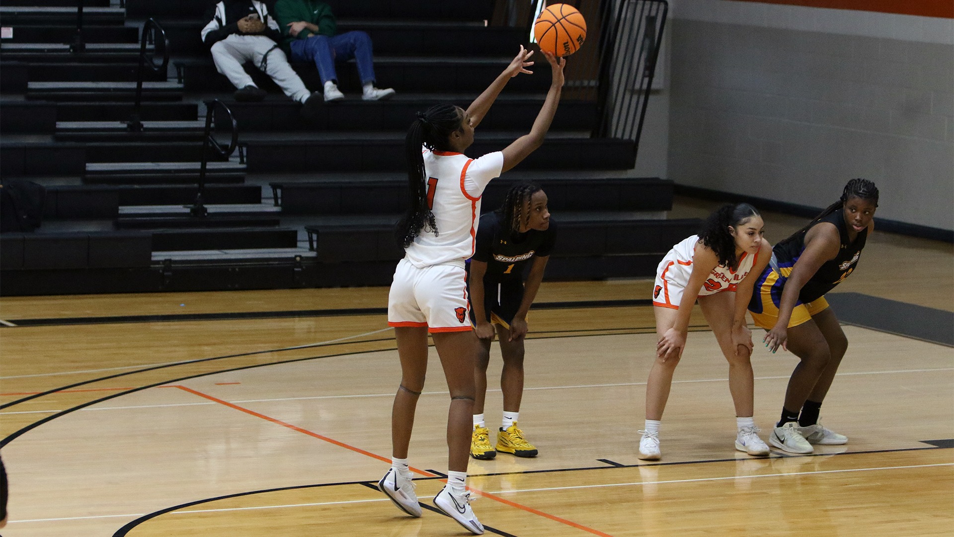 Mia deJesus in white jersey shooting a free throw