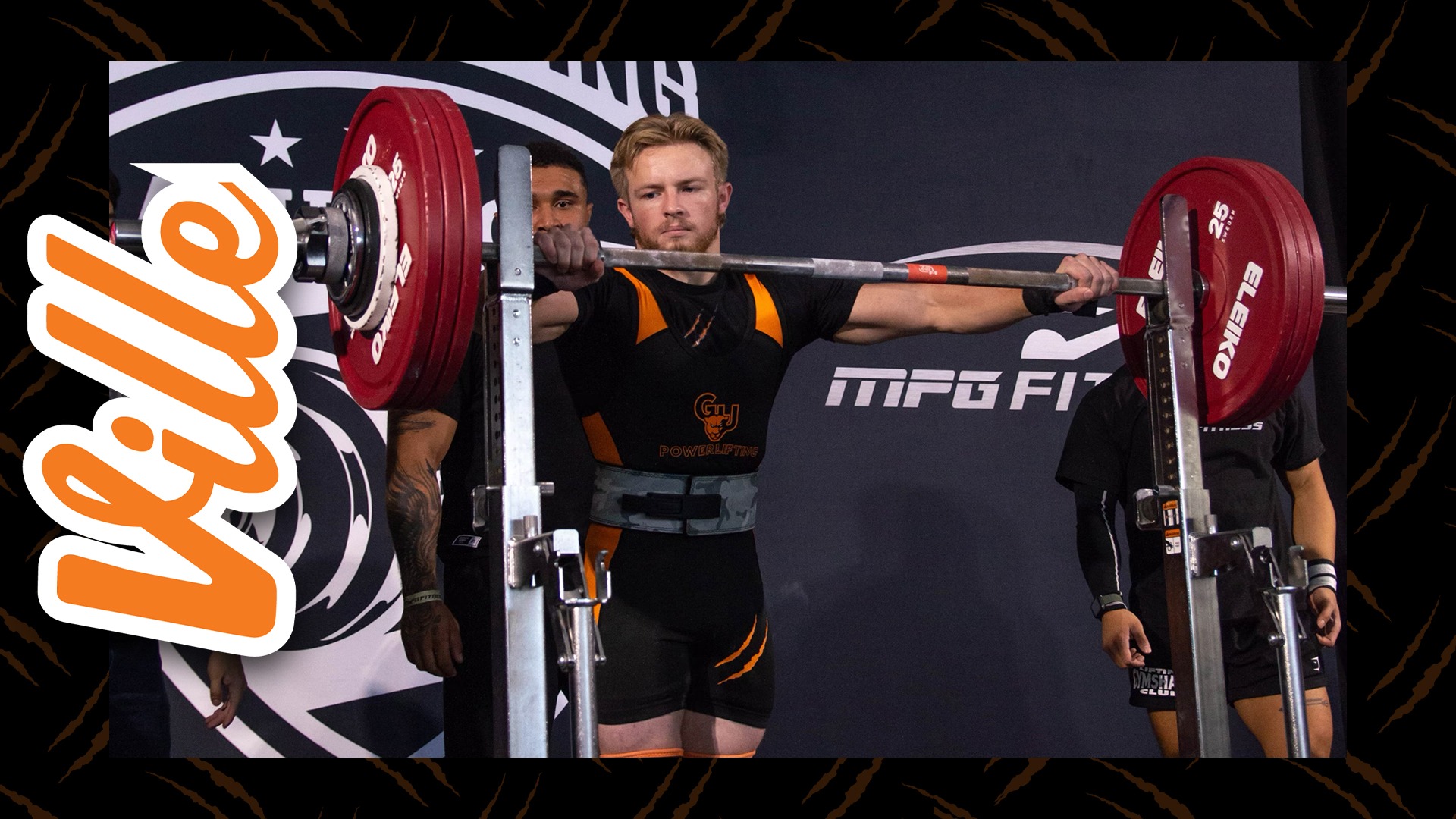 A young man with short blond hair and beard approaches a metal bar with red weights on the ends. The man wears a white and orange singlet.