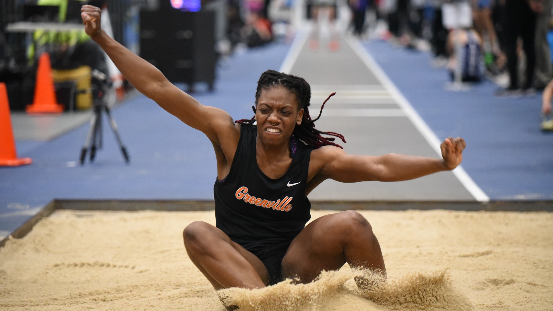 Jazmyn Harmon landing in sand after jump