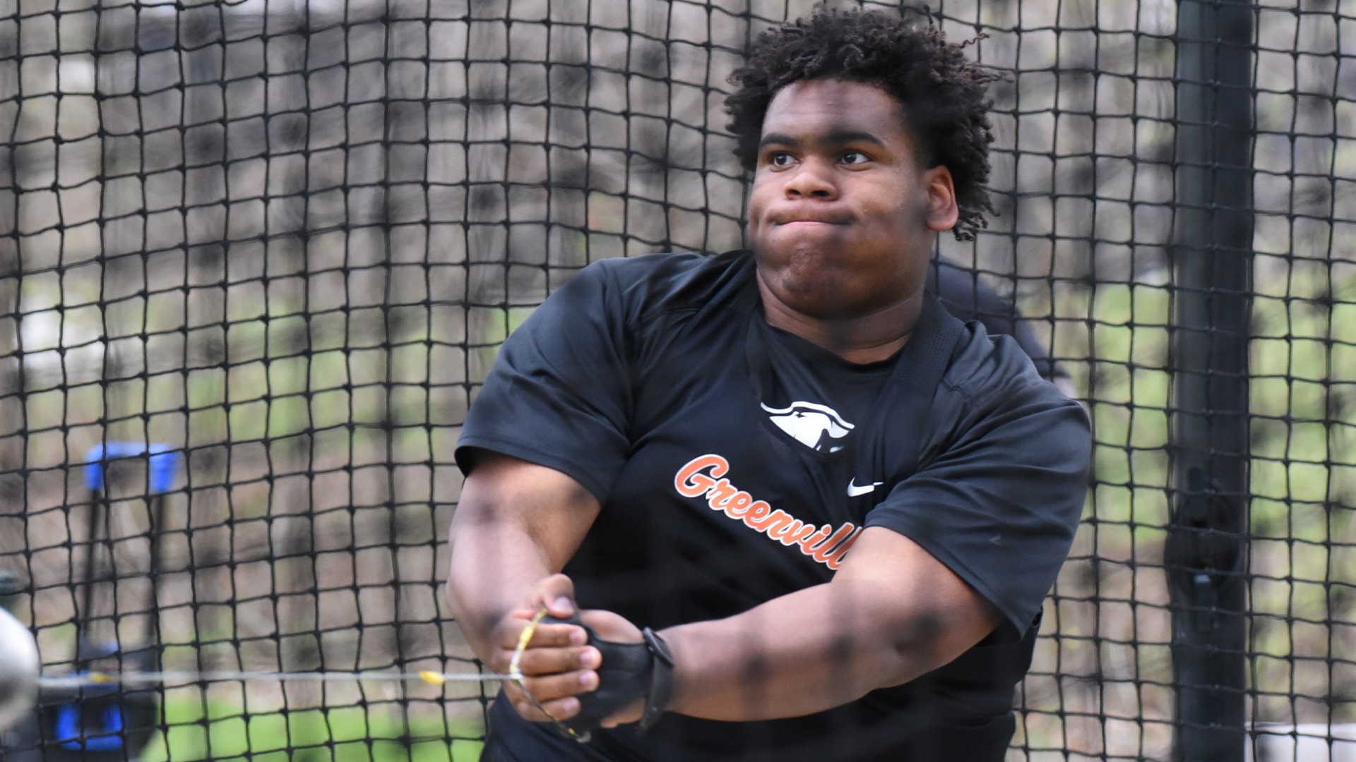 Andre Harper in black shirt throwing hammer