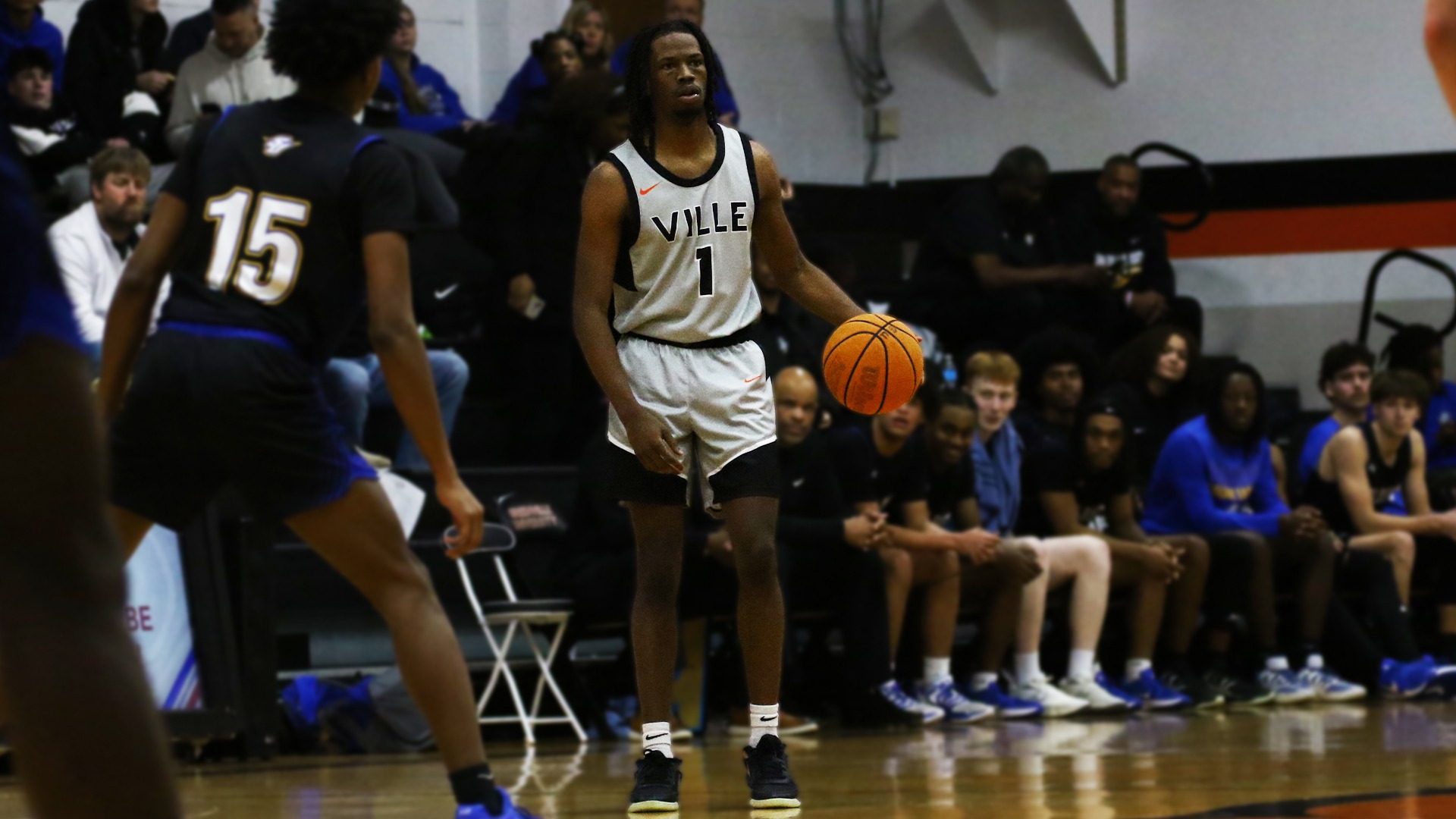 Josh Williford in grey jersey dribbling ball