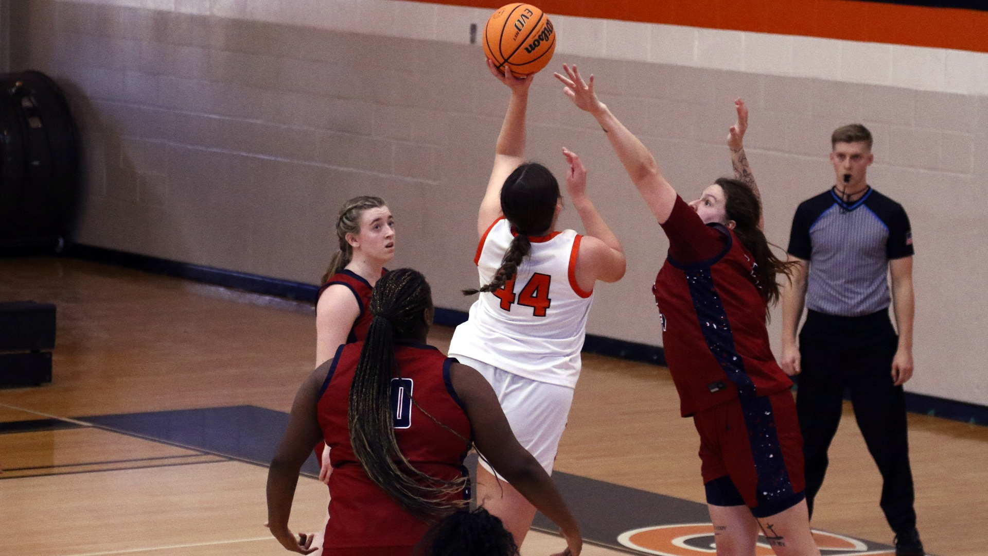 Alyssa Seymour in white jersey laying the ball up past Lyon player in maroon jersey