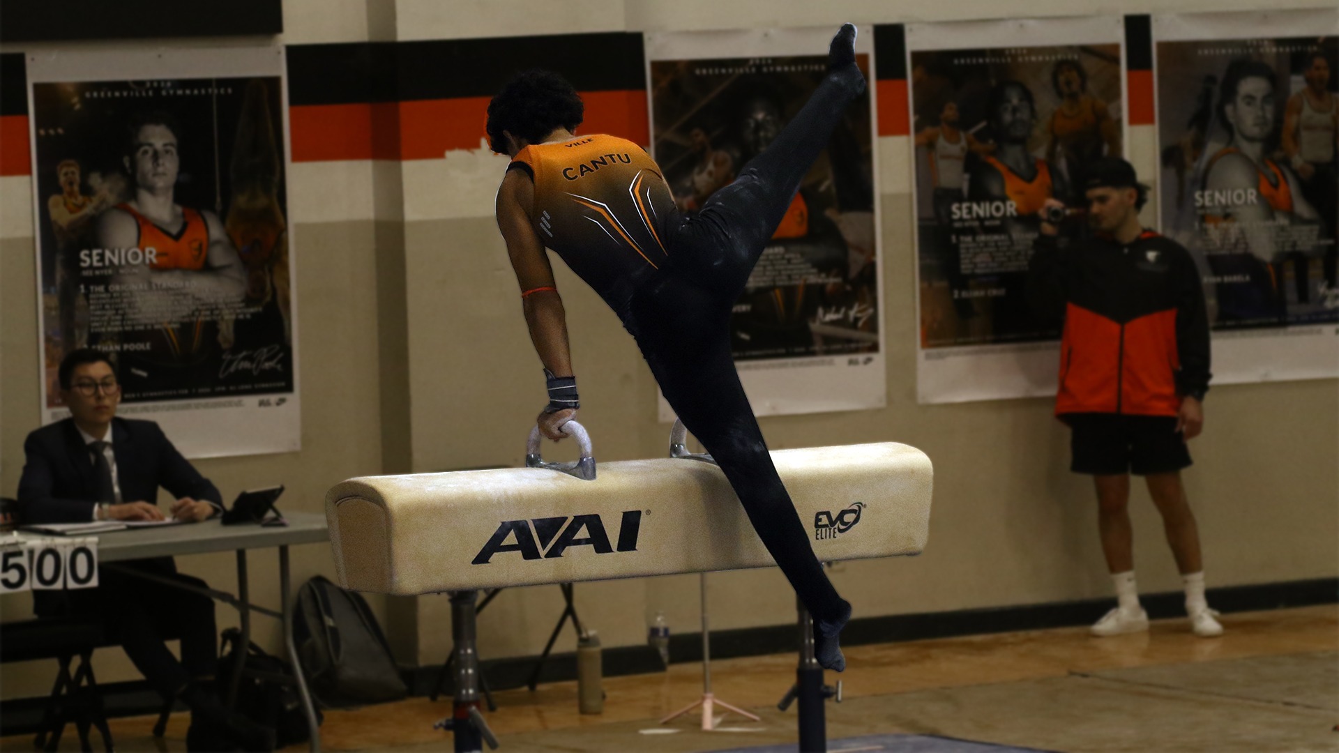 Koby Cantu in orange and black uniform with leg in air on pommel