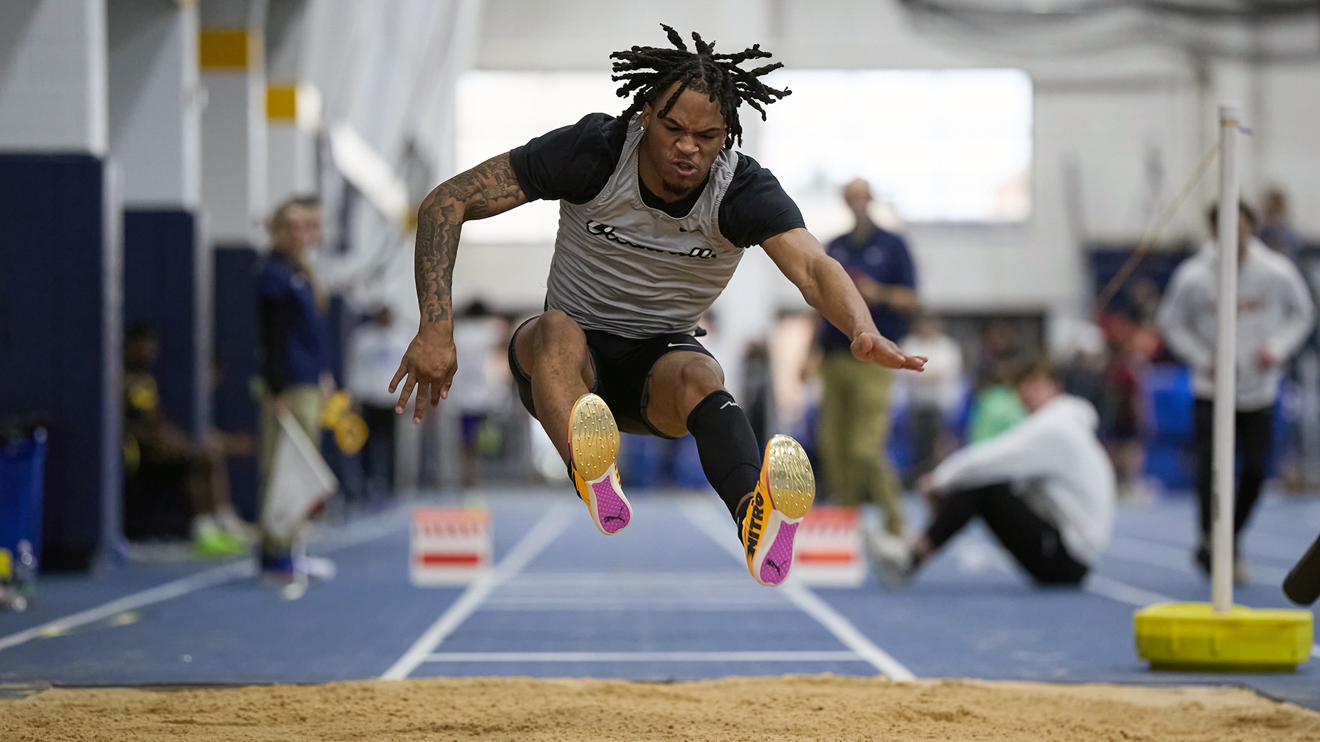 Panther athlete jumping in sand pit for horizontal jumps