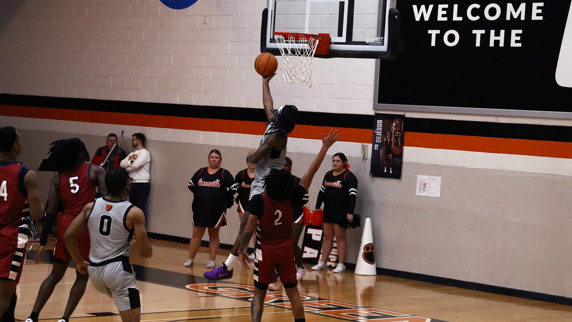 Elliott Mobley doing a reverse layup over a lyon player