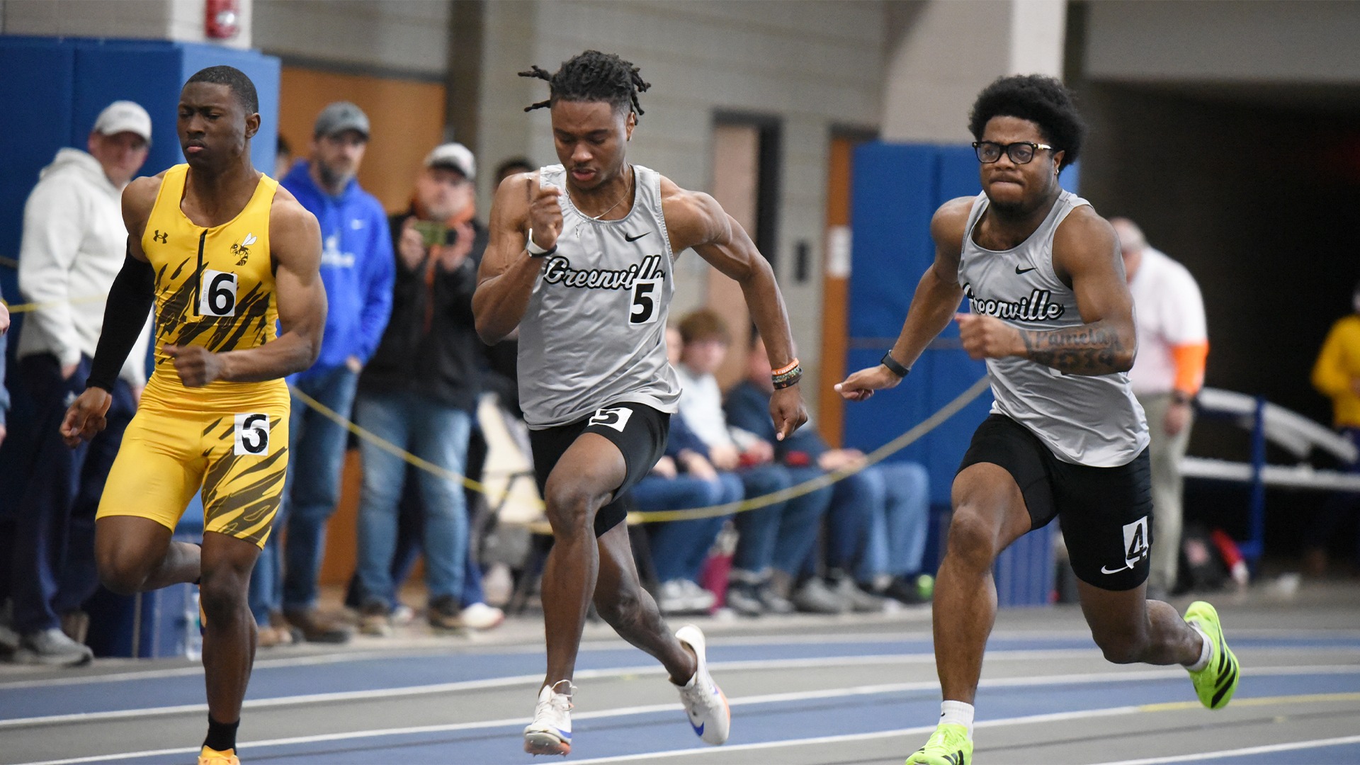 Kellum and Gibson in grey uniforms sprinting indoors