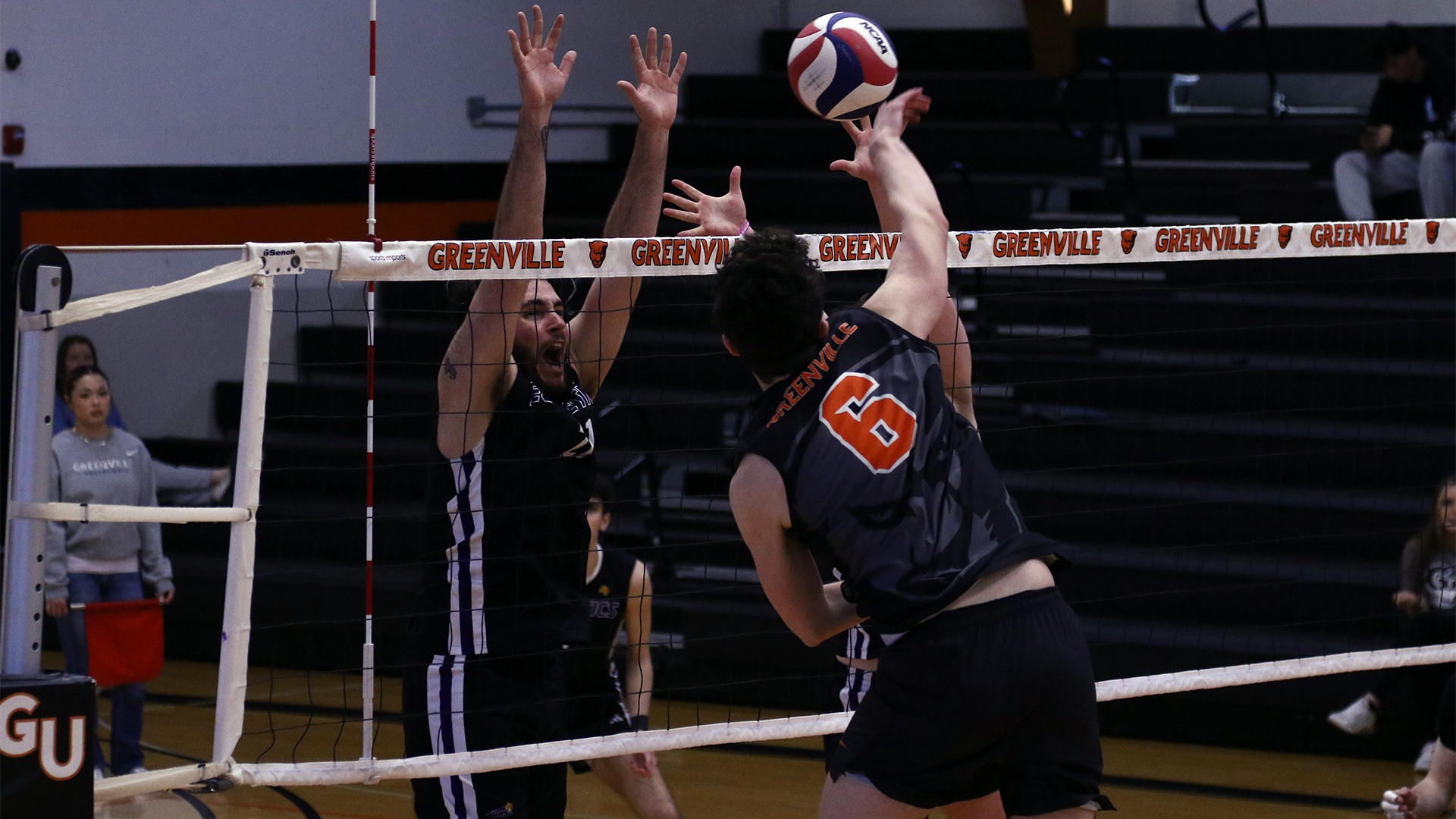 Carson Hulsey in black jersey attacking ball at net