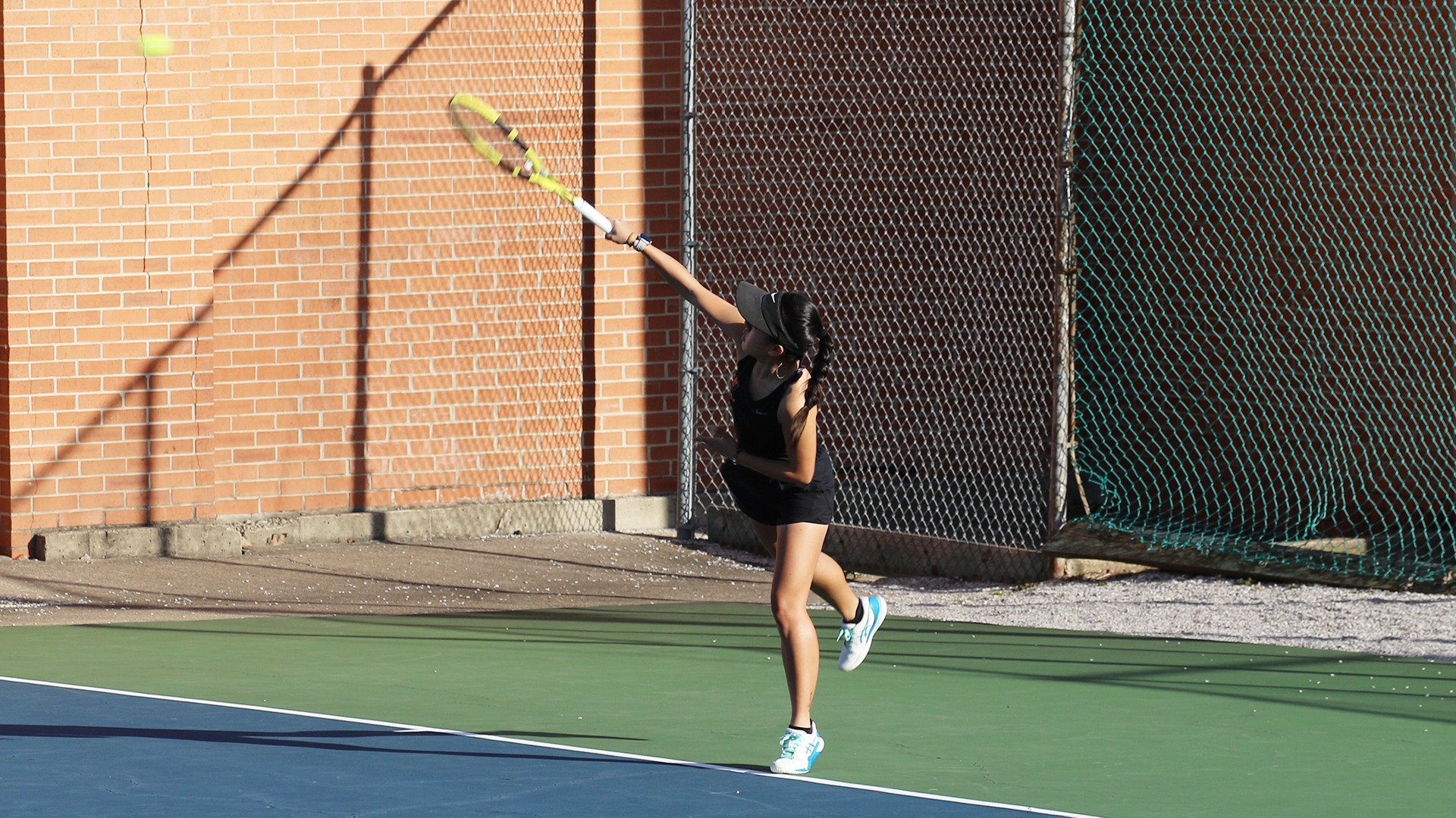 Evie Johnson serving ball