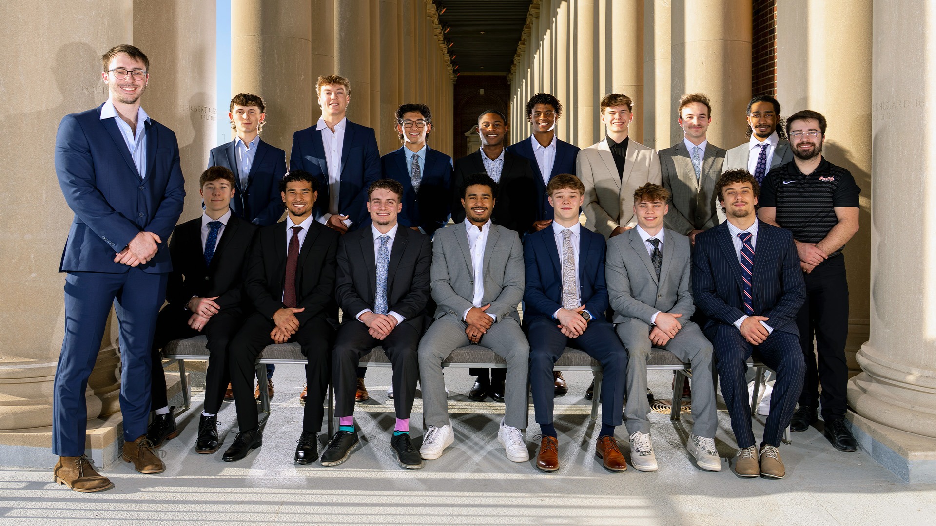 Group picture of mgym team in suits at banquet